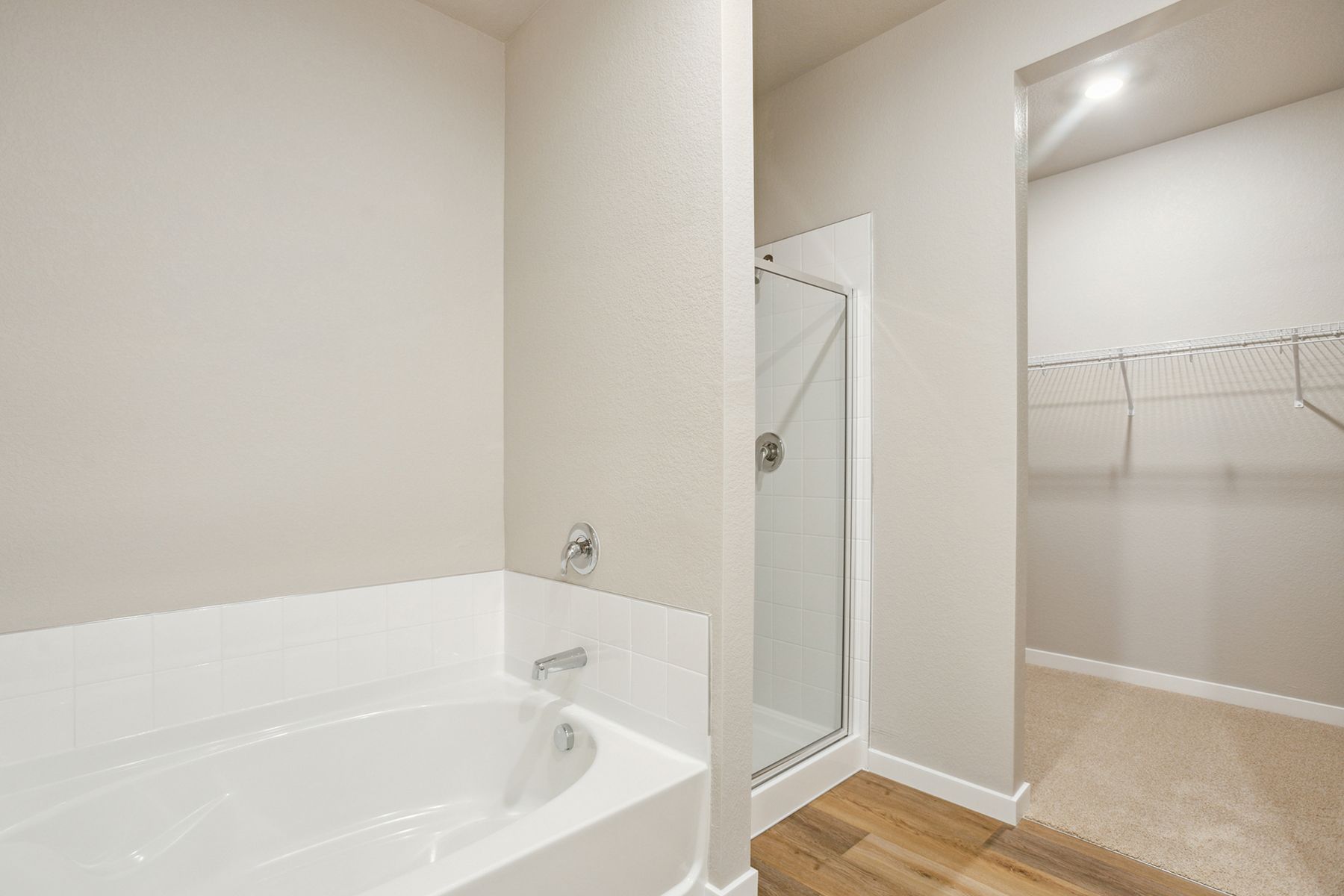 The master bathroom has a soaking tub and a step in shower.