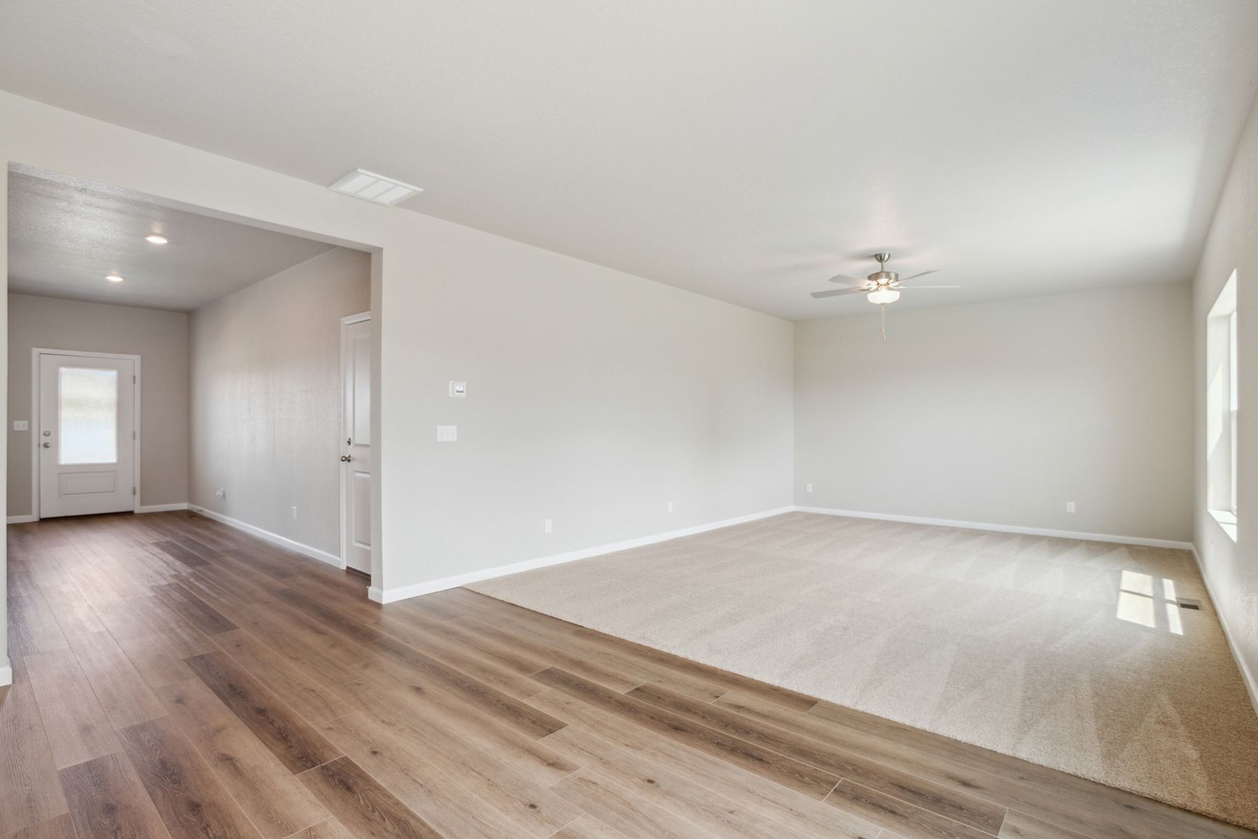 The family room is spacious with a ceiling fan.
