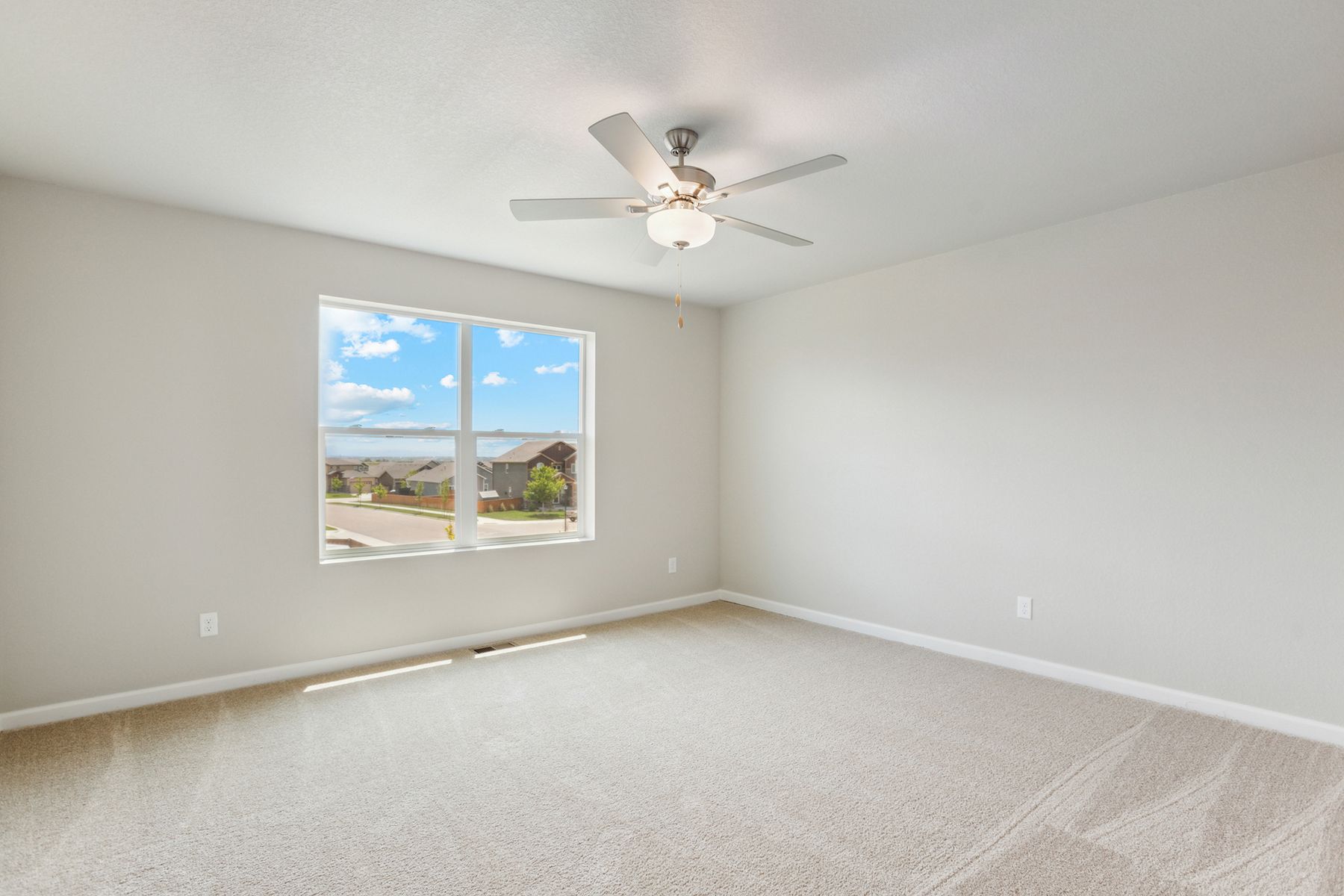 The master bedroom is spacious and has carpet.