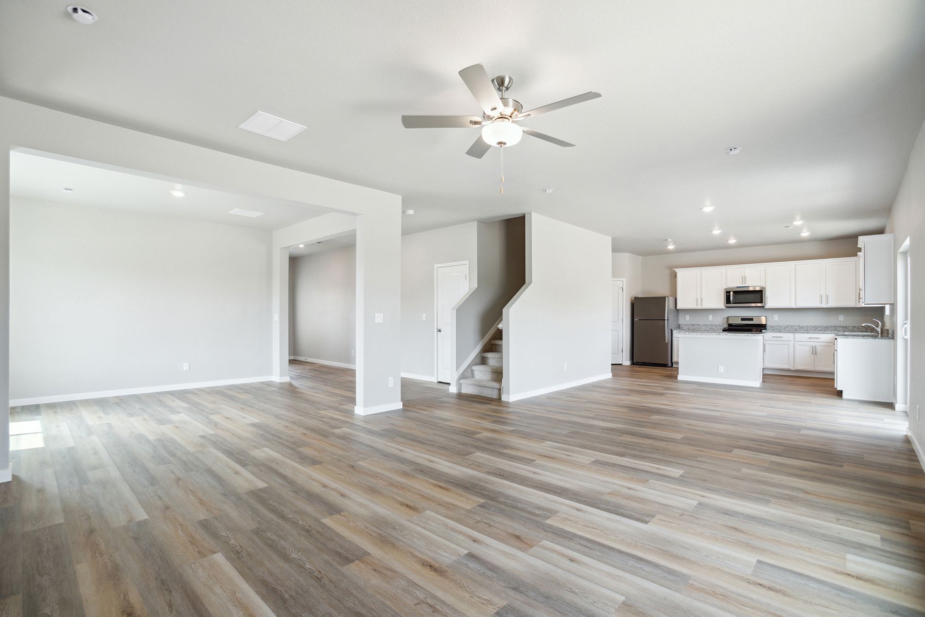The family room is spacious with a ceiling fan.