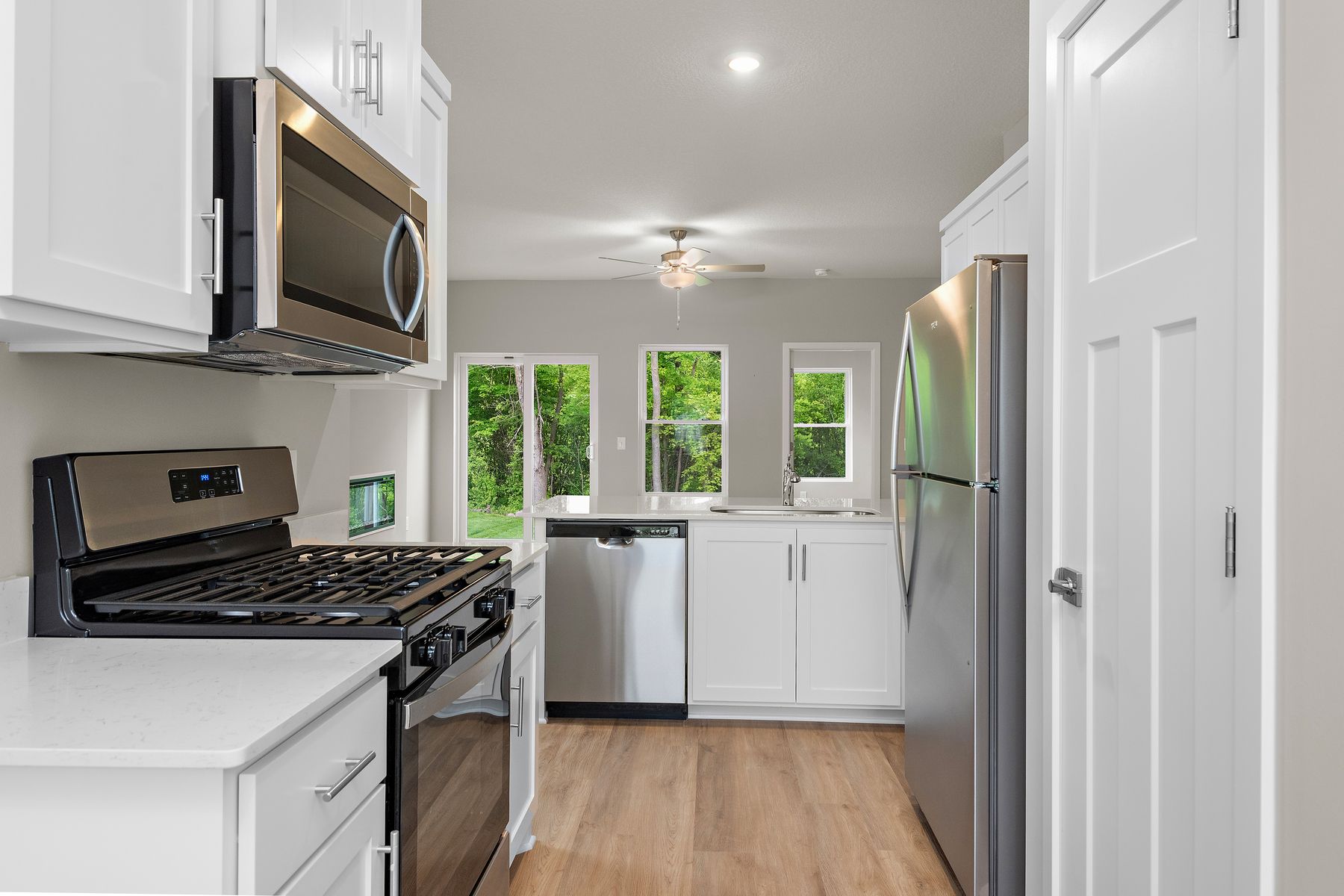 The family room is spacious with a ceiling fan.