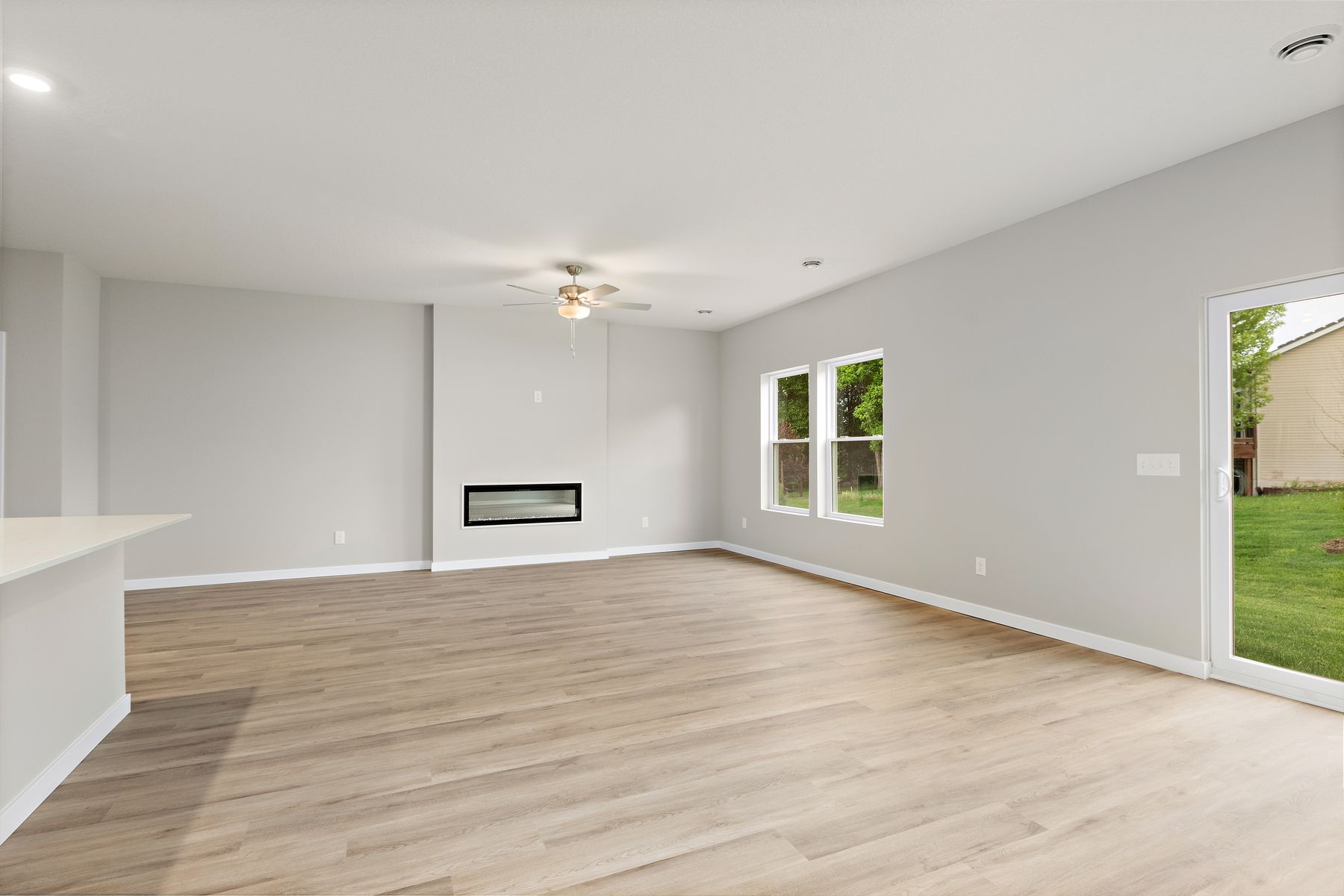 The family room is spacious with a ceiling fan.