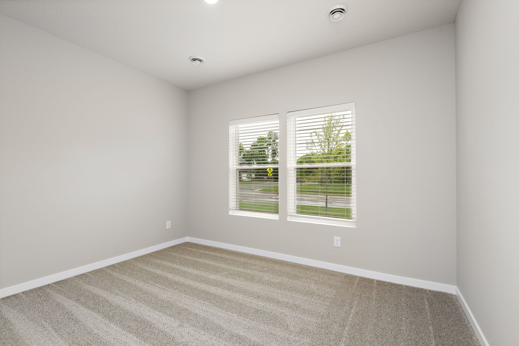The master bedroom is spacious and has carpet.