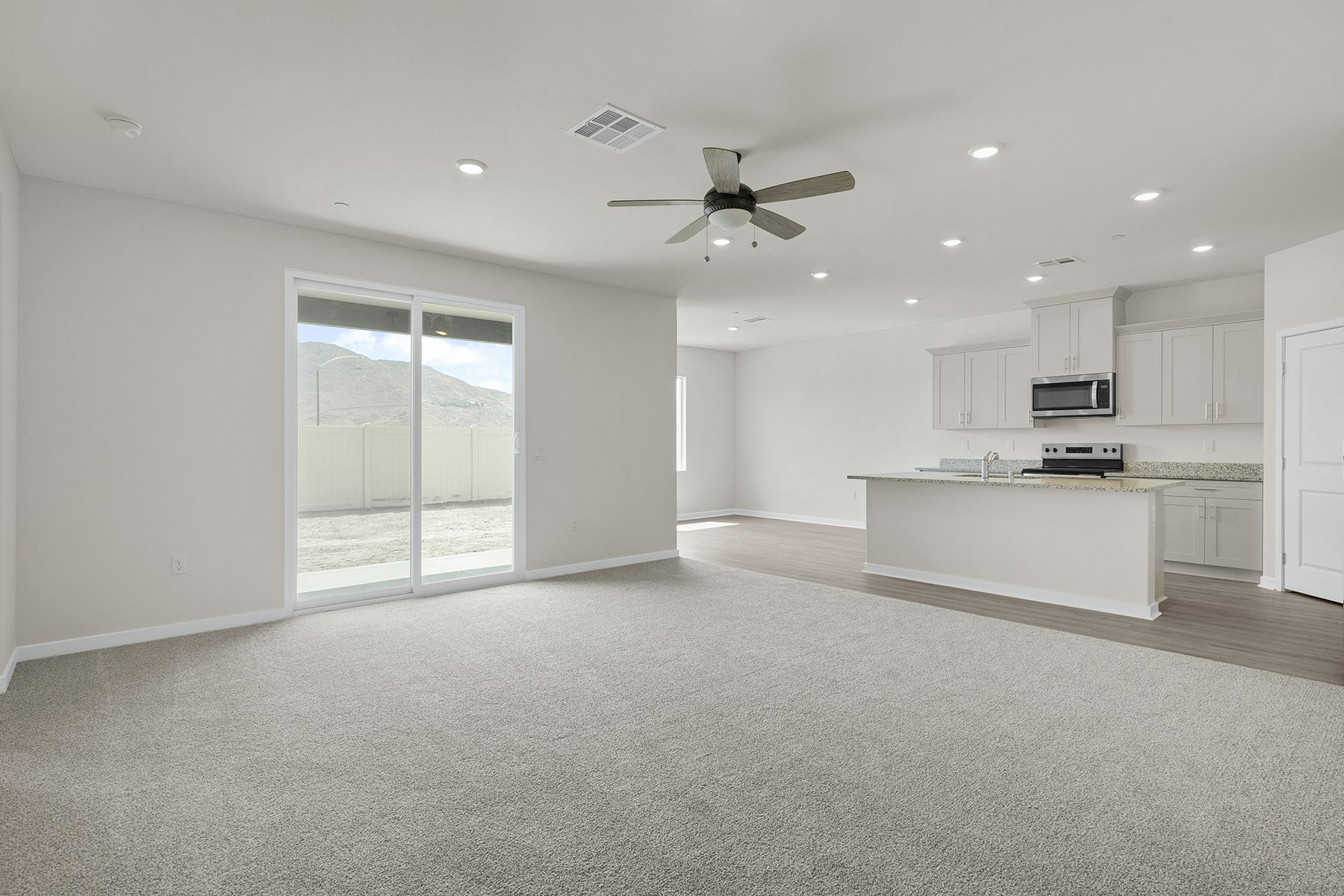 The family room is spacious with a ceiling fan.