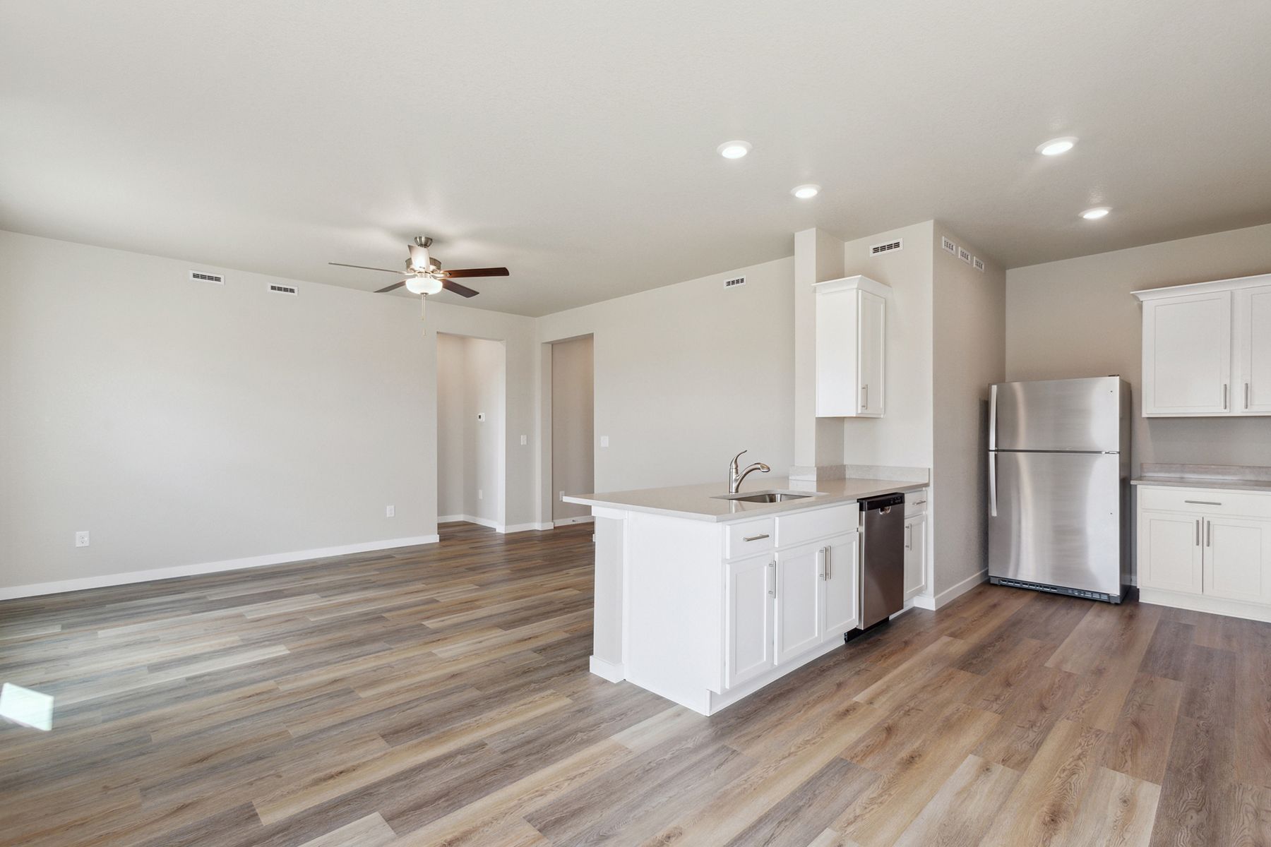 The family room is spacious with a ceiling fan.