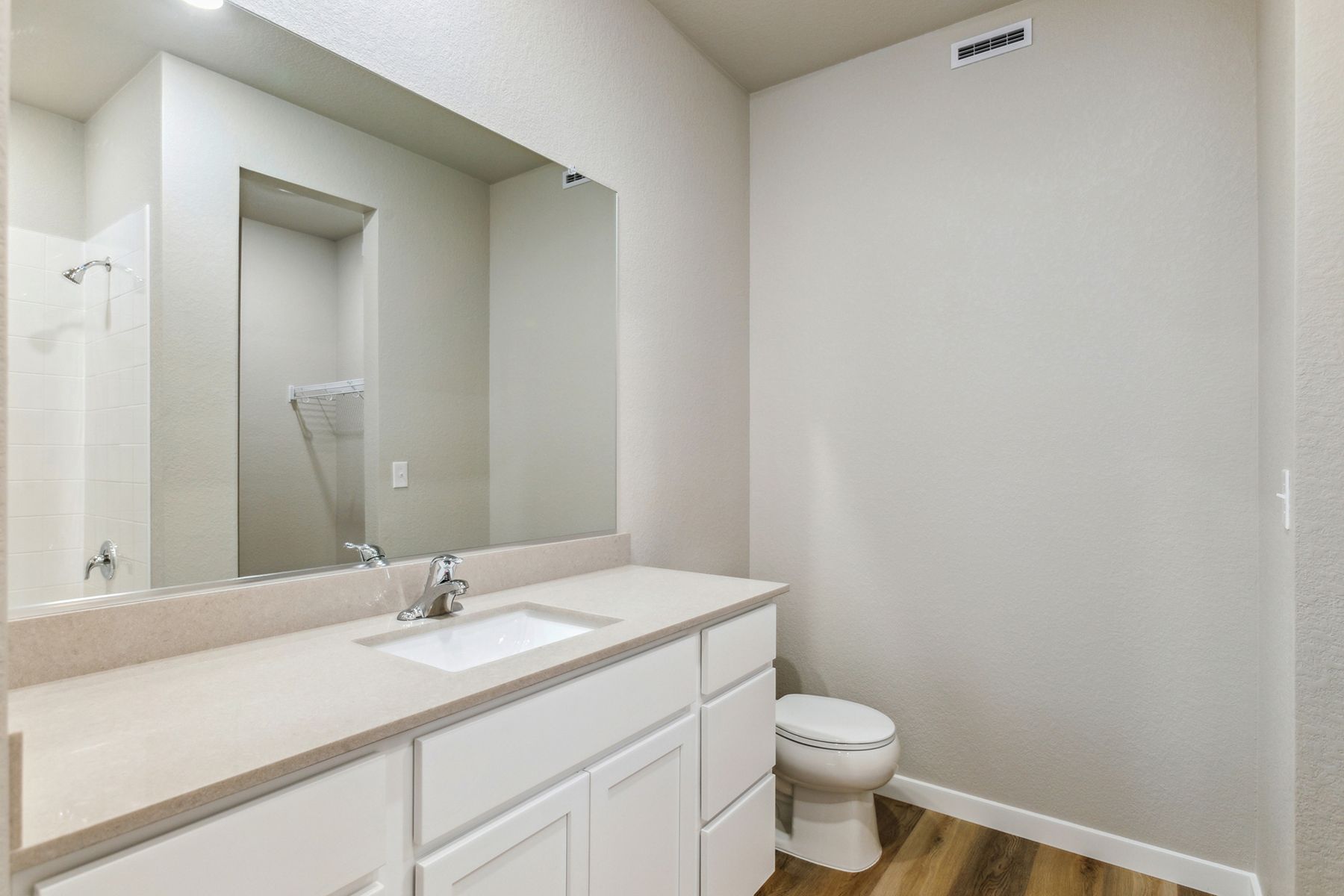 The master bathroom has a large vanity.