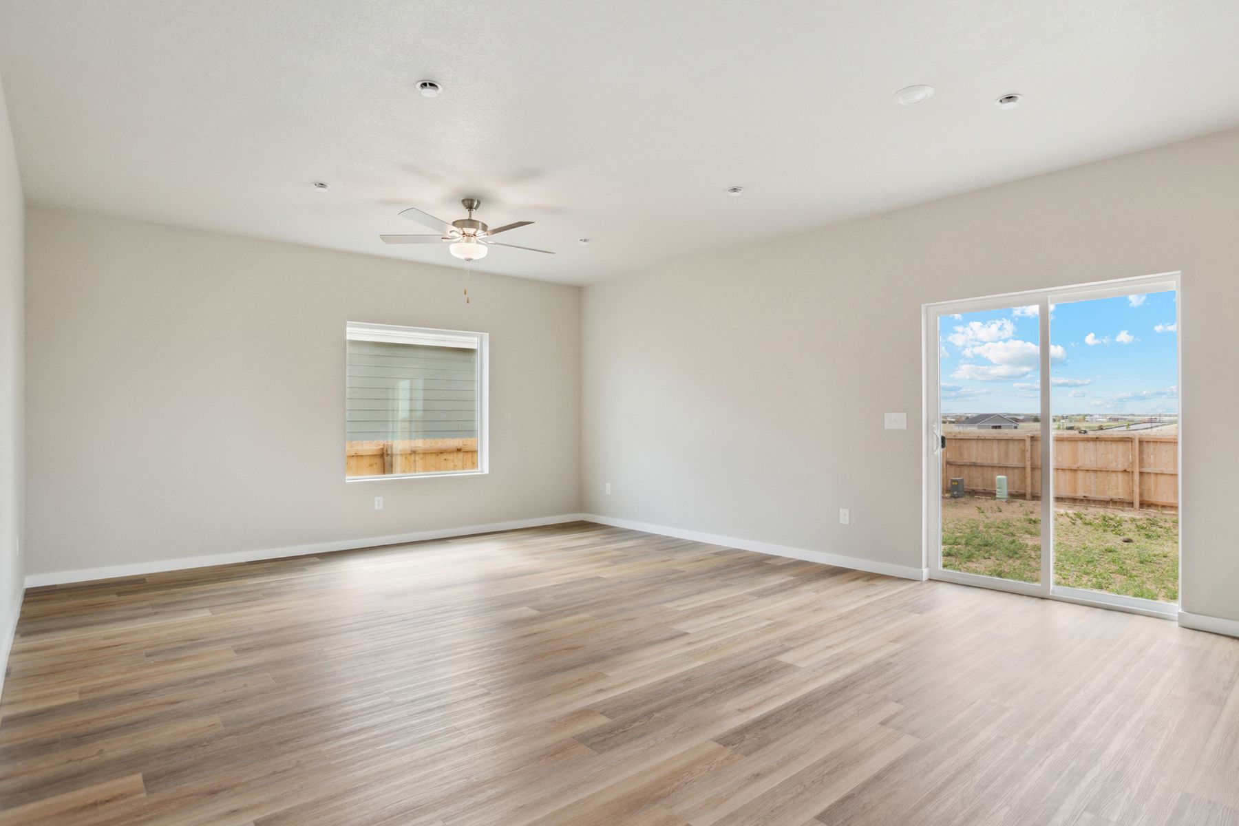 The family room is spacious with a ceiling fan.