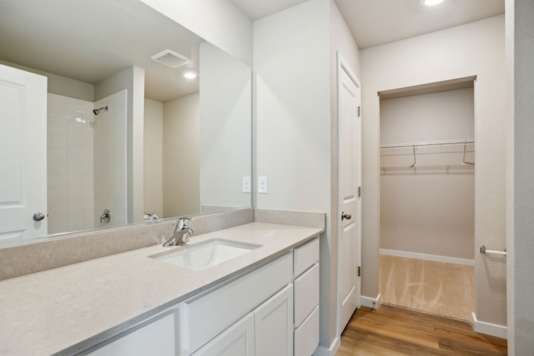 The master bathroom has a large vanity.
