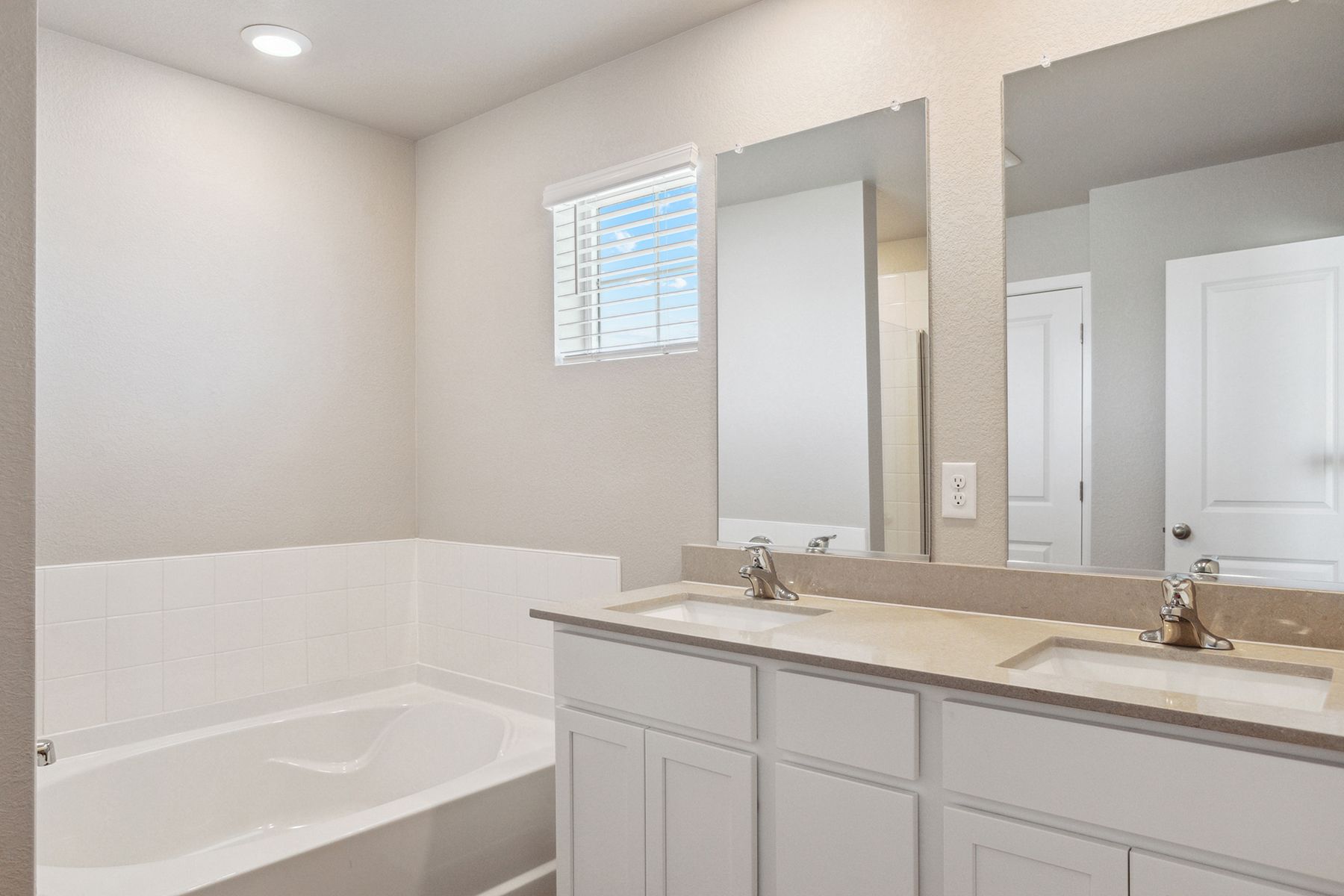 The master bathroom has a large vanity.