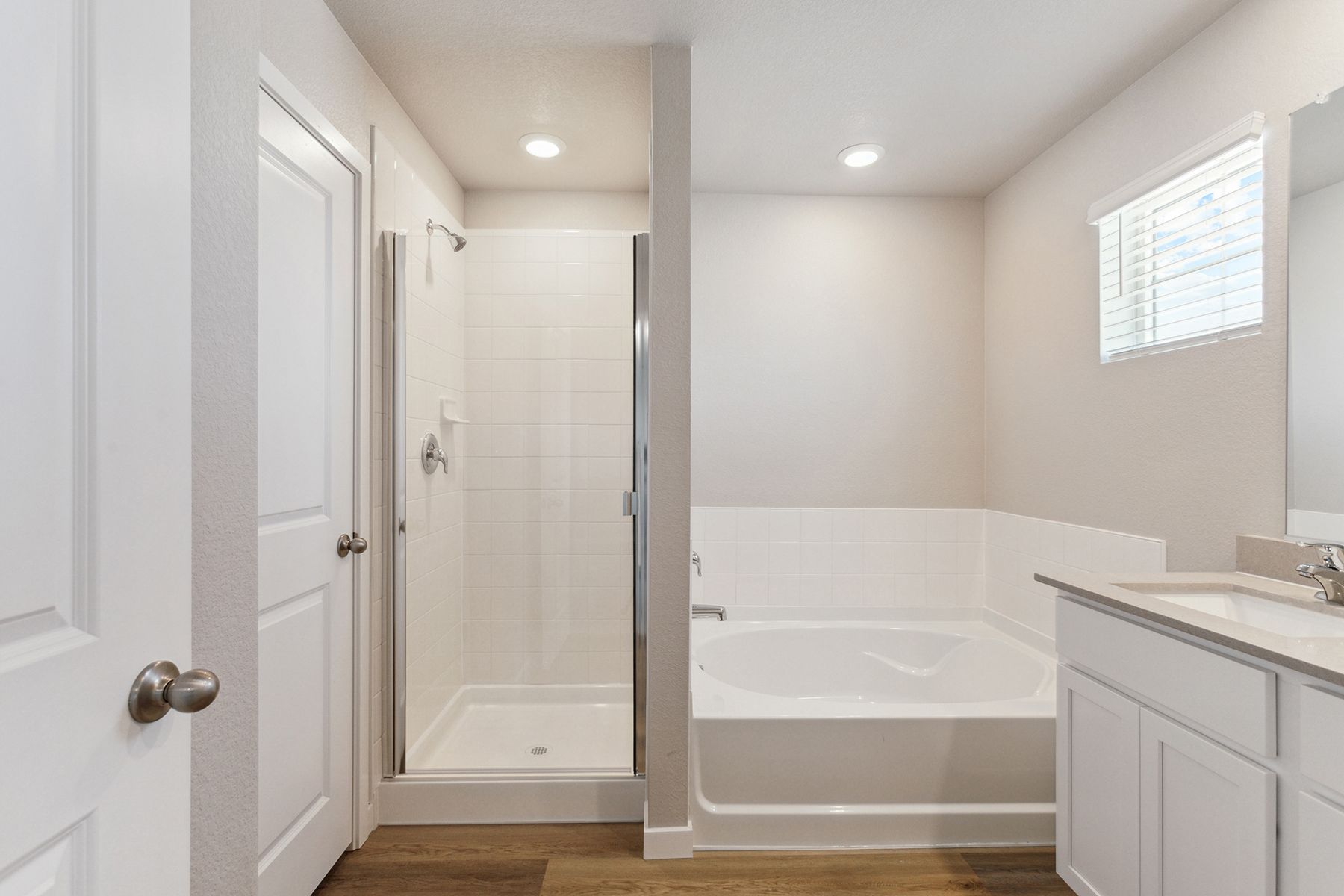 The master bathroom has a step in shower and a soaking tub.
