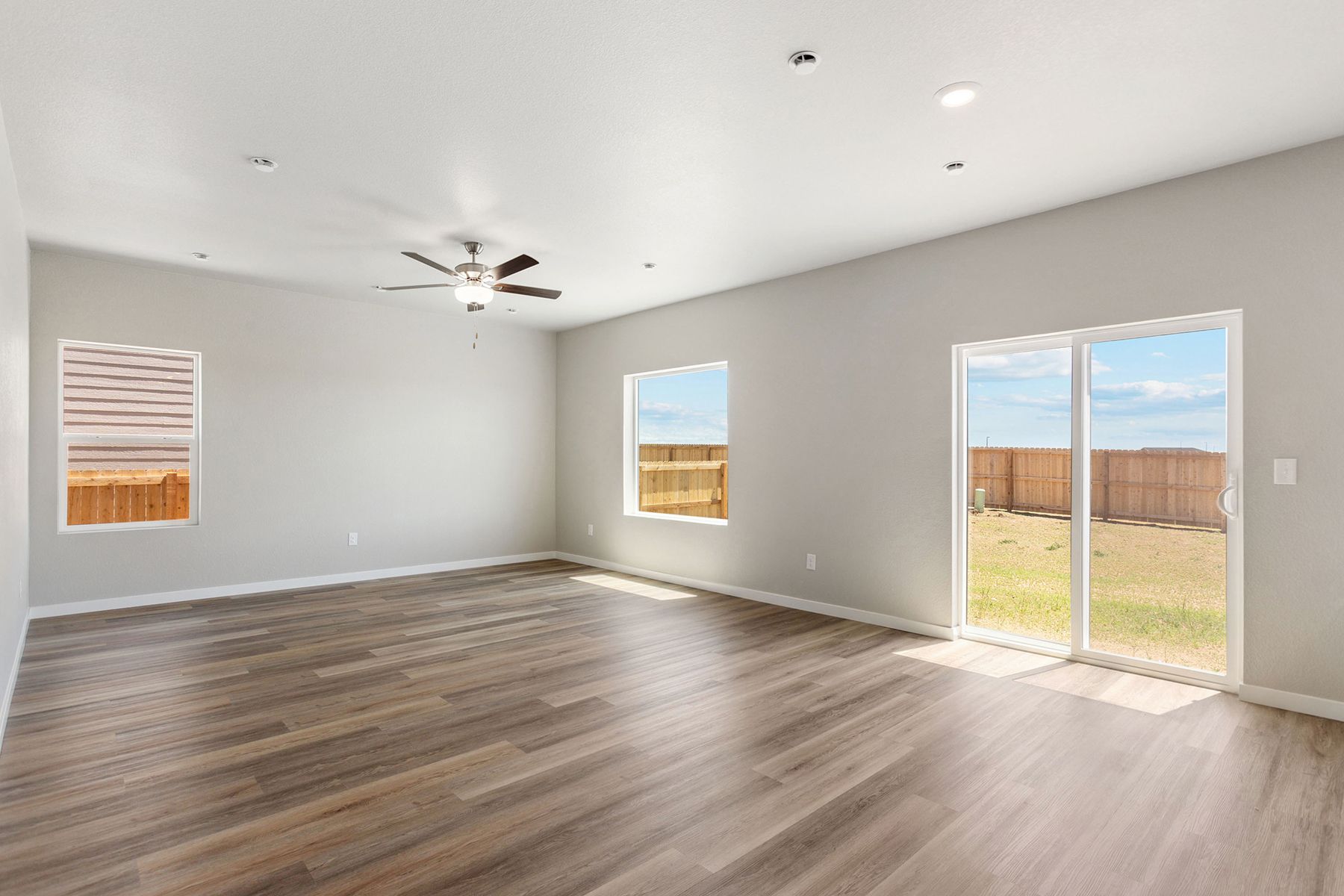 The family room is spacious with a ceiling fan.
