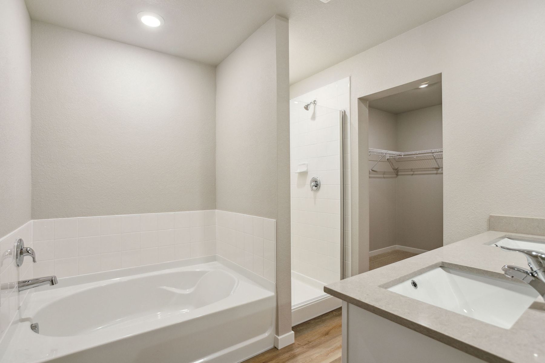 The master bathroom has a step in showr and soaking tub.