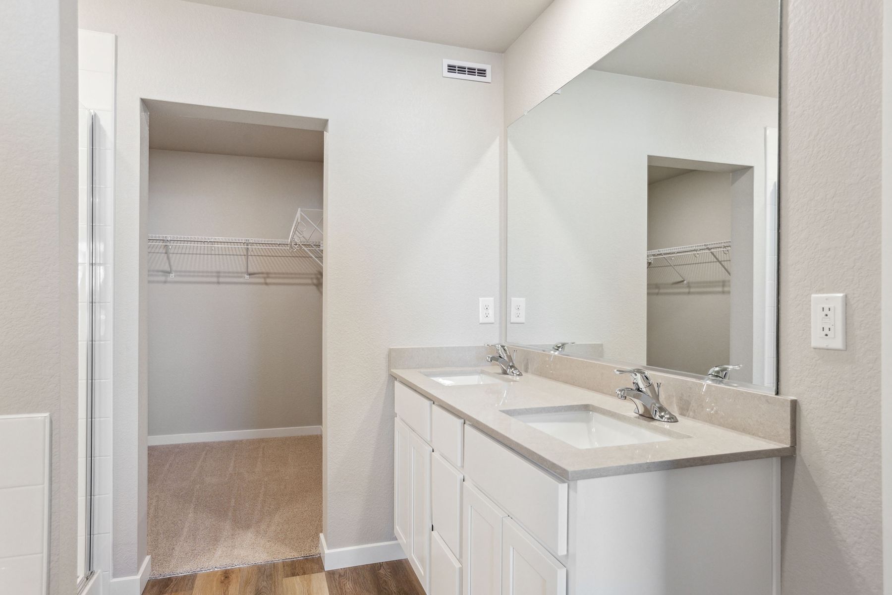 The master bathroom has a large vanity.