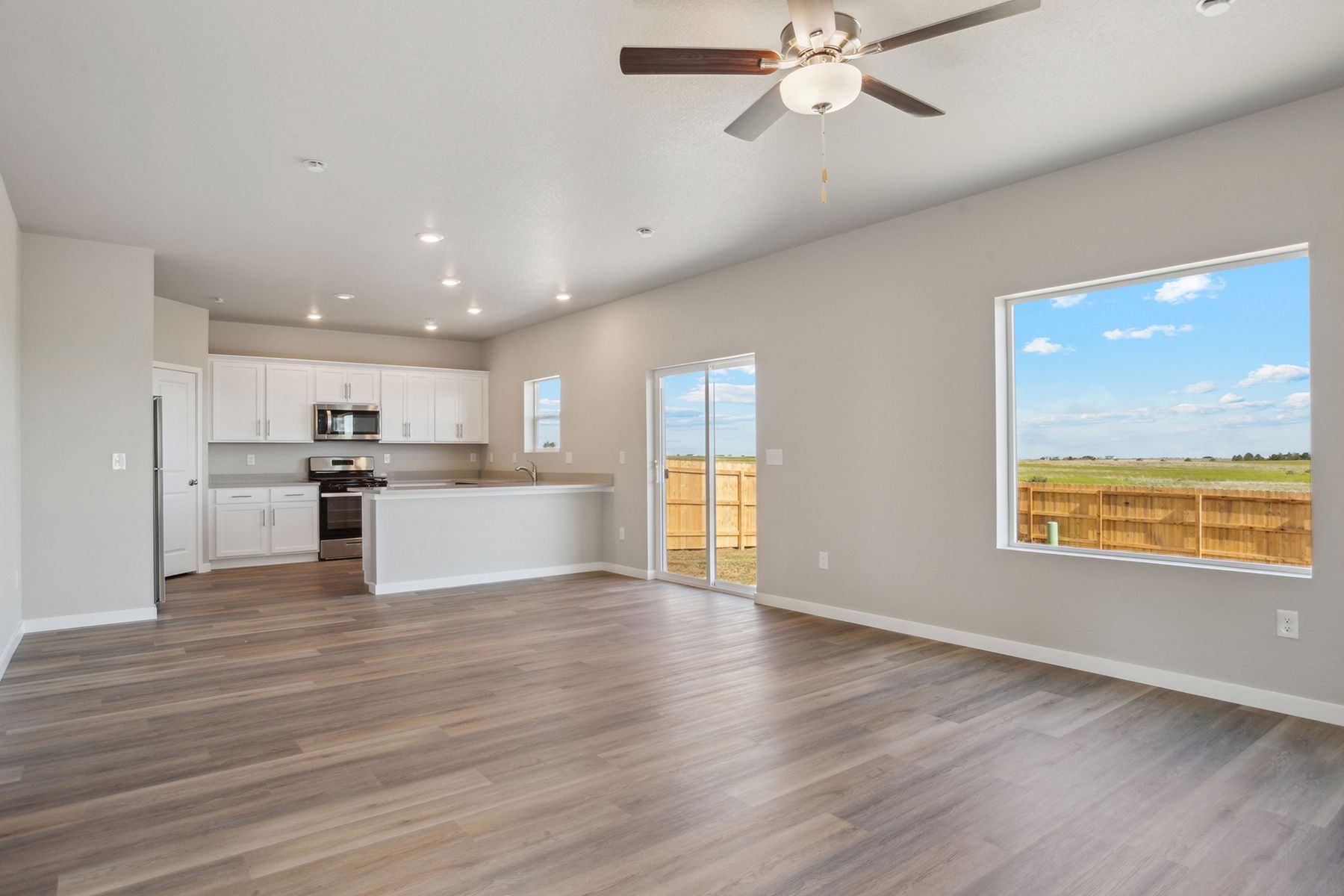 The family room is spacious with a ceiling fan.