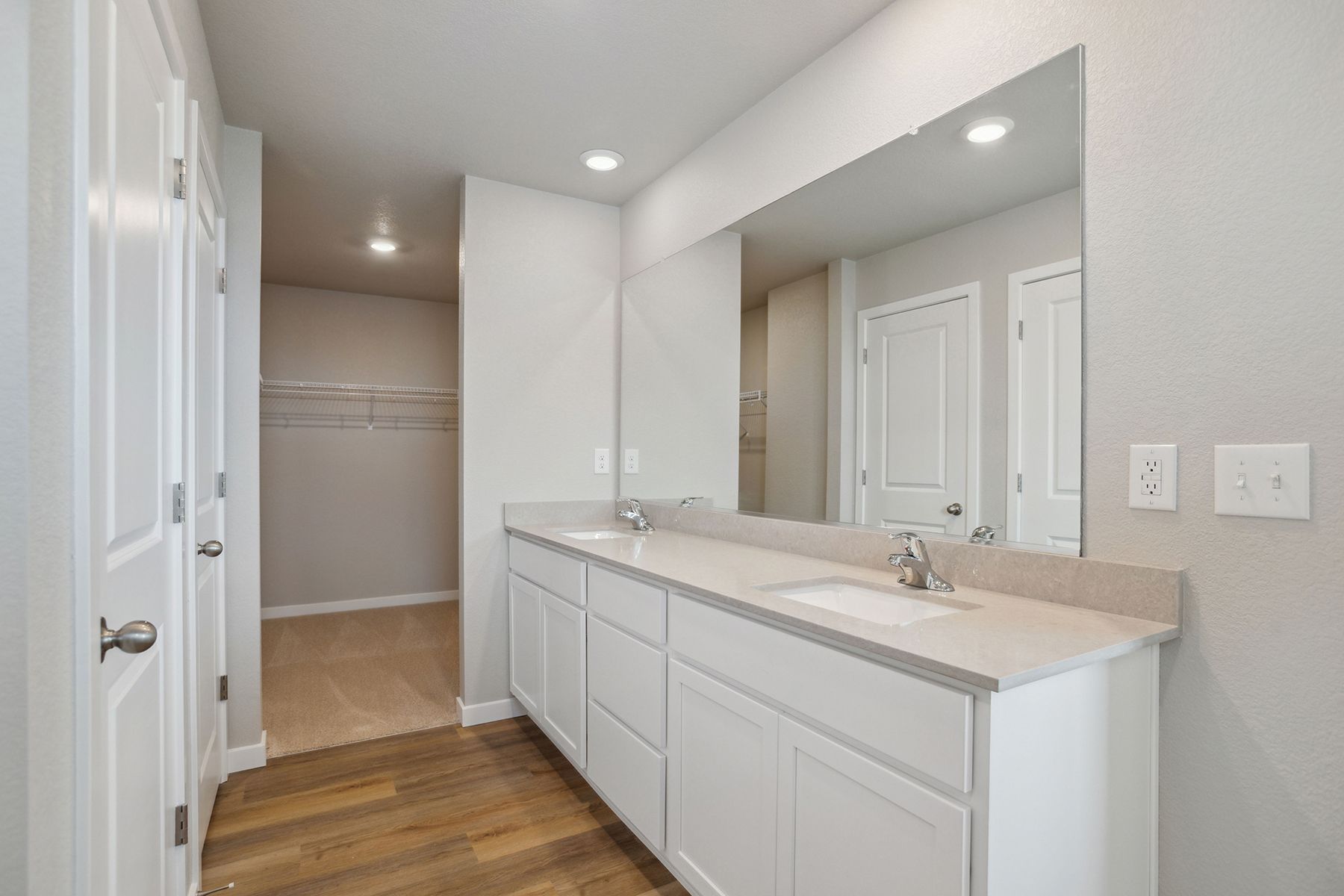 The master bathroom has a large vanity.
