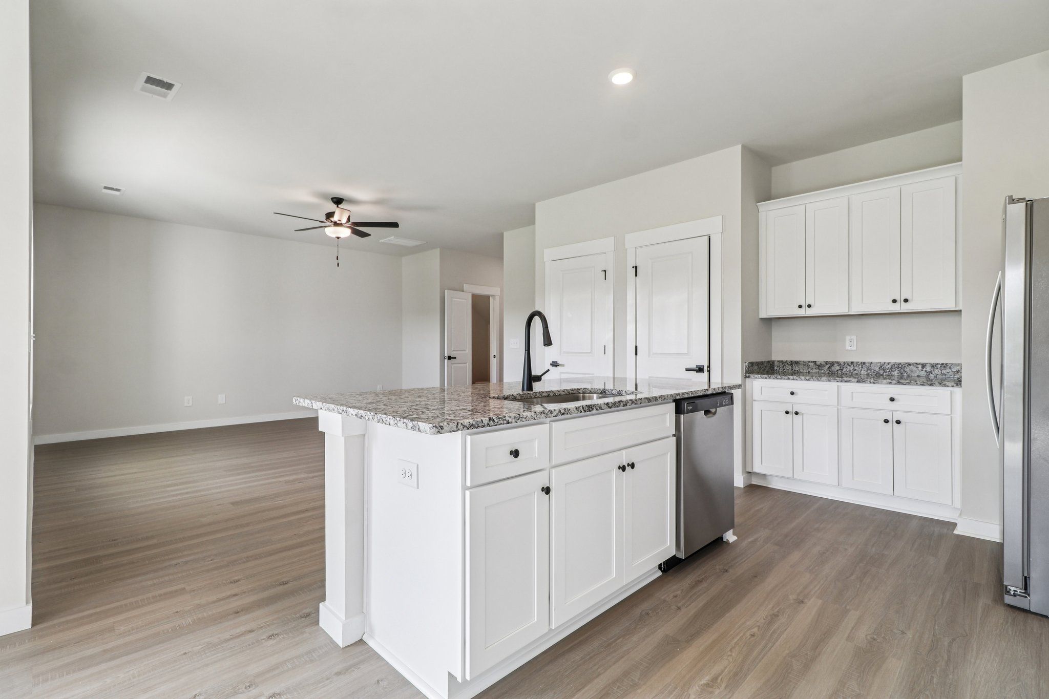 The kitchen has designer wood cabinetry.
