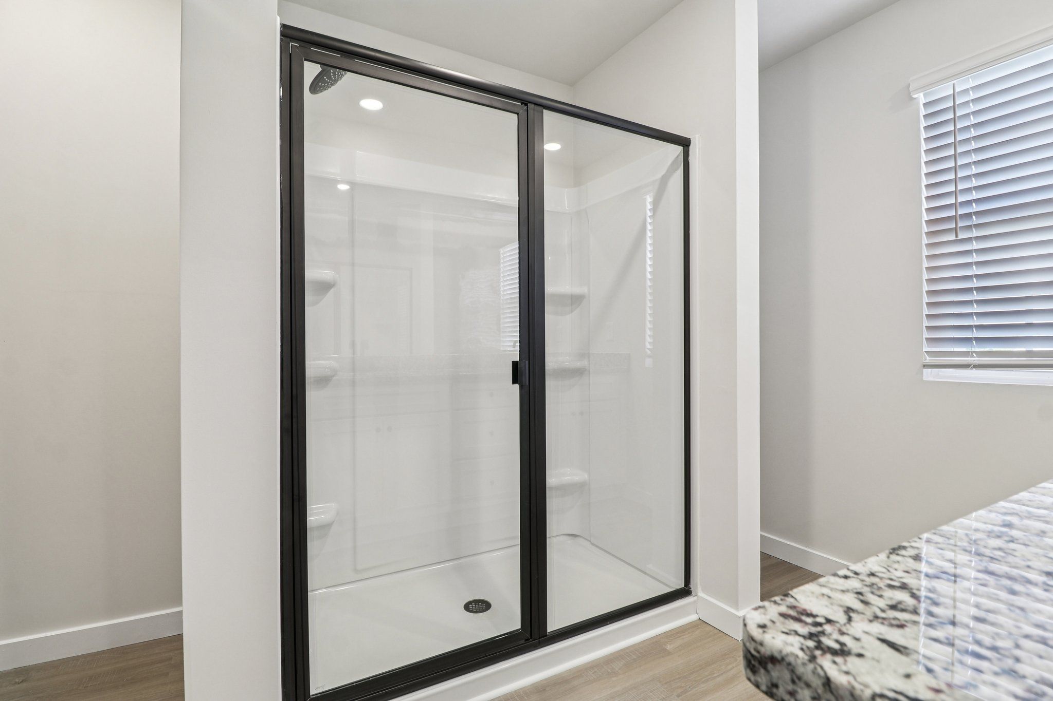 The master has a glass-enclosed shower