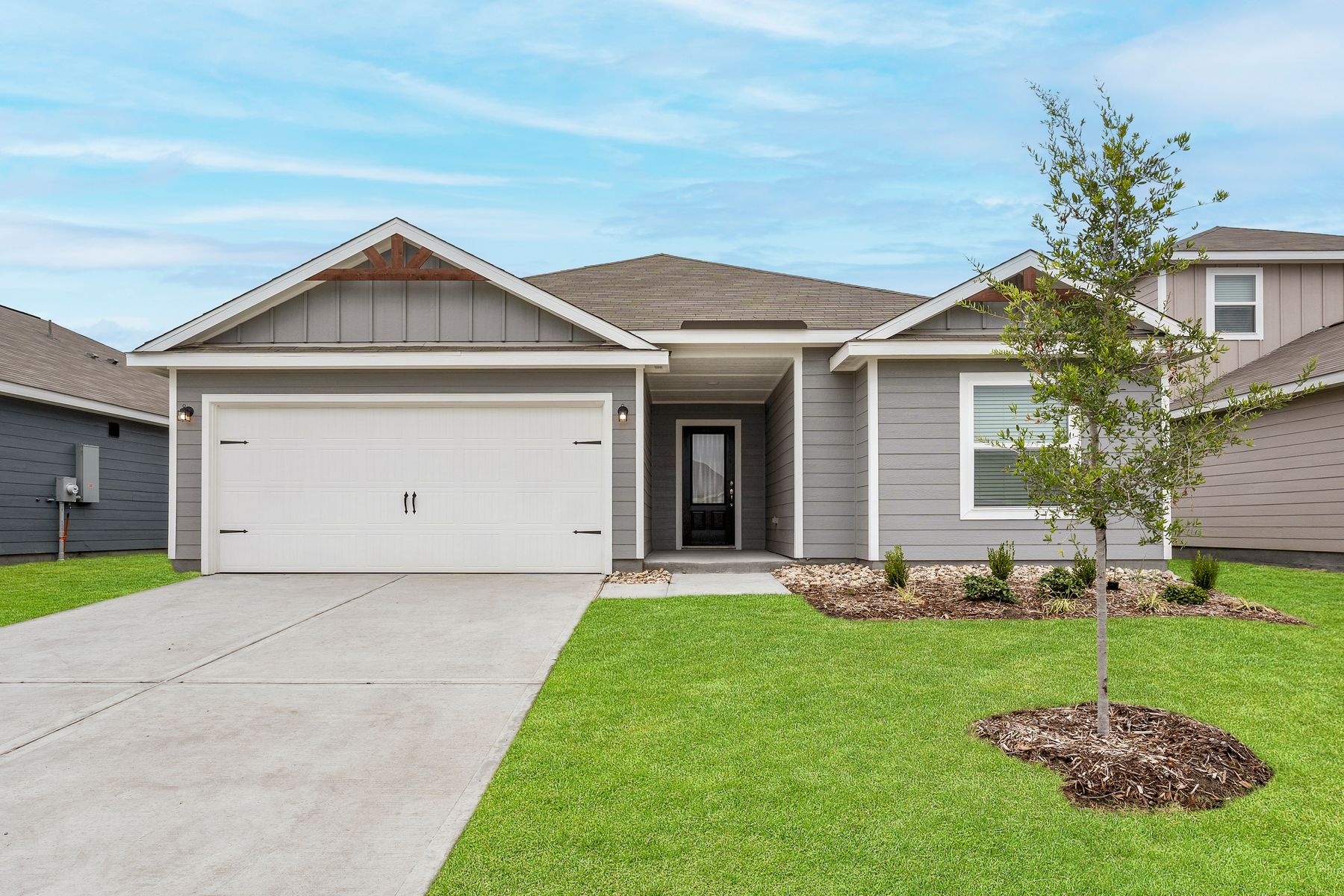The Reed is a beautiful one-story siding home with wood detail.