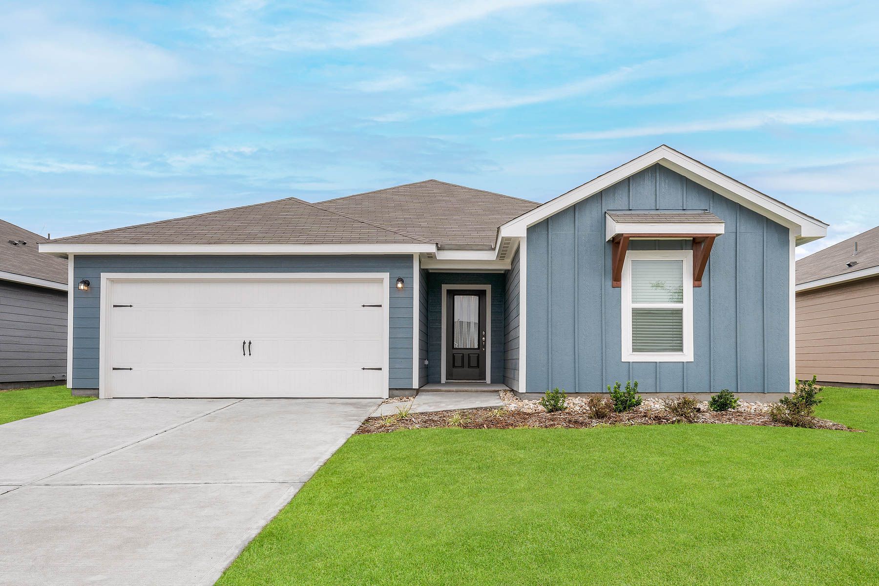 The Sabine is a beautiful one-story siding home with wood detail.