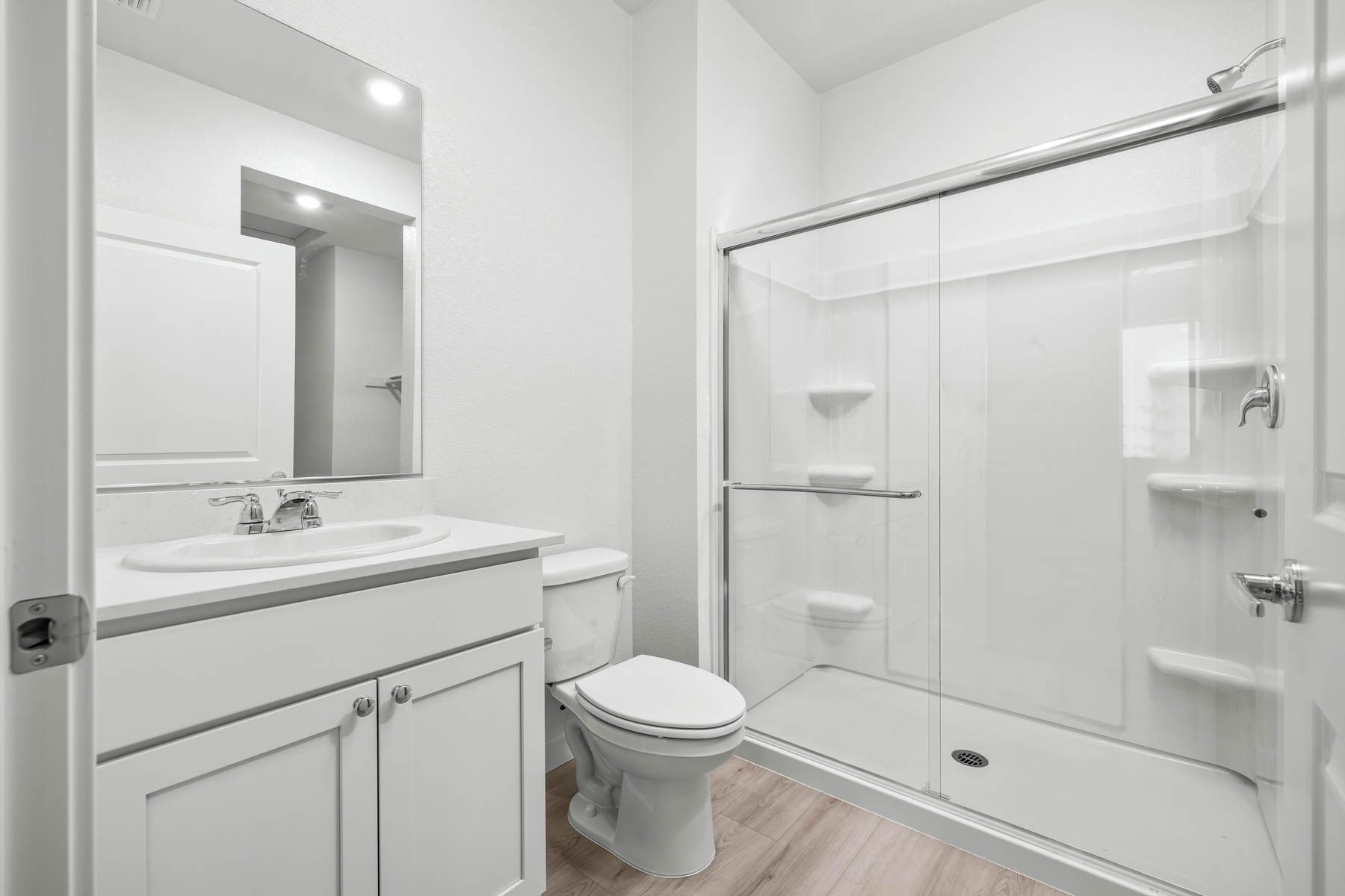 The master bathroom has a large vanity and step in shower.