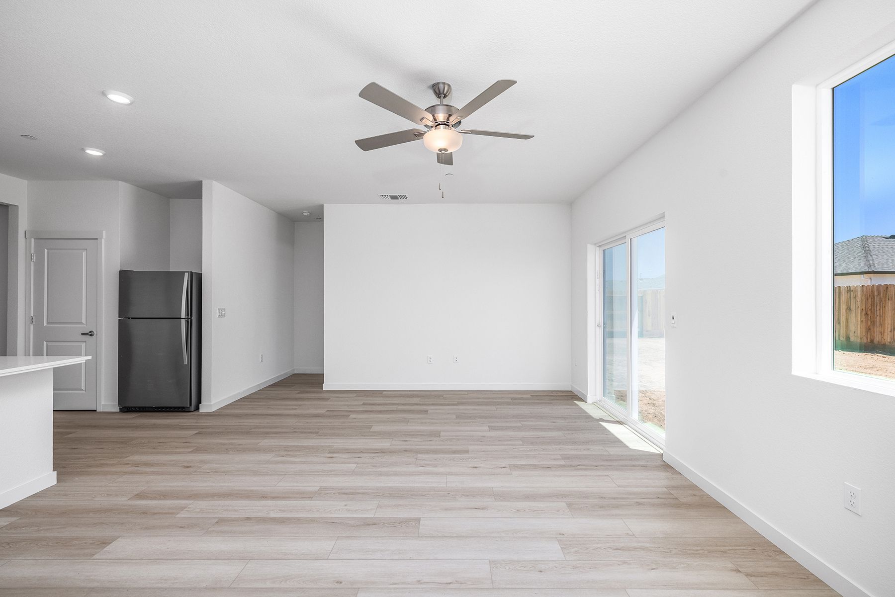 The family room is spacious with a ceiling fan.