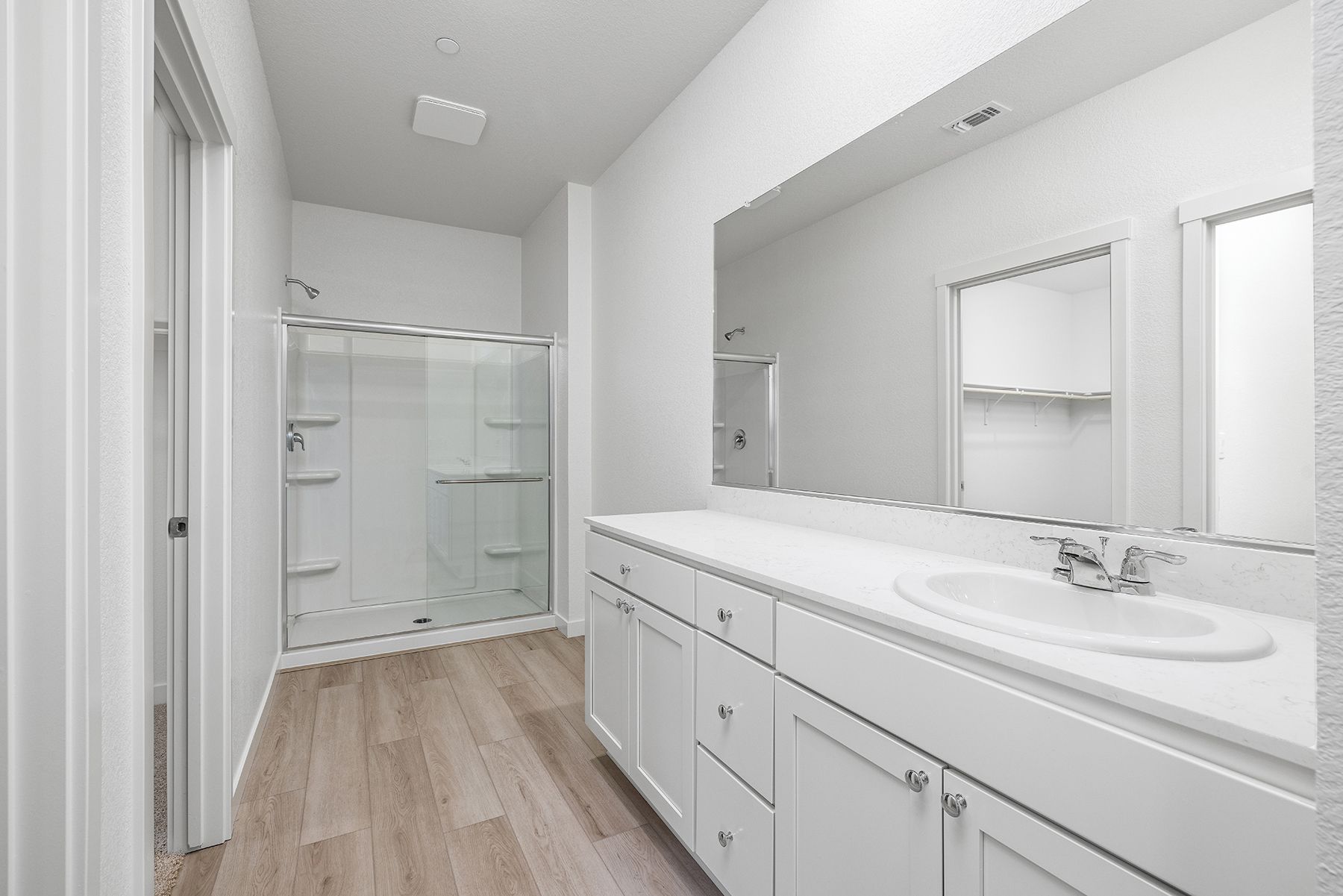 The master bathroom has a dual sink vanity.