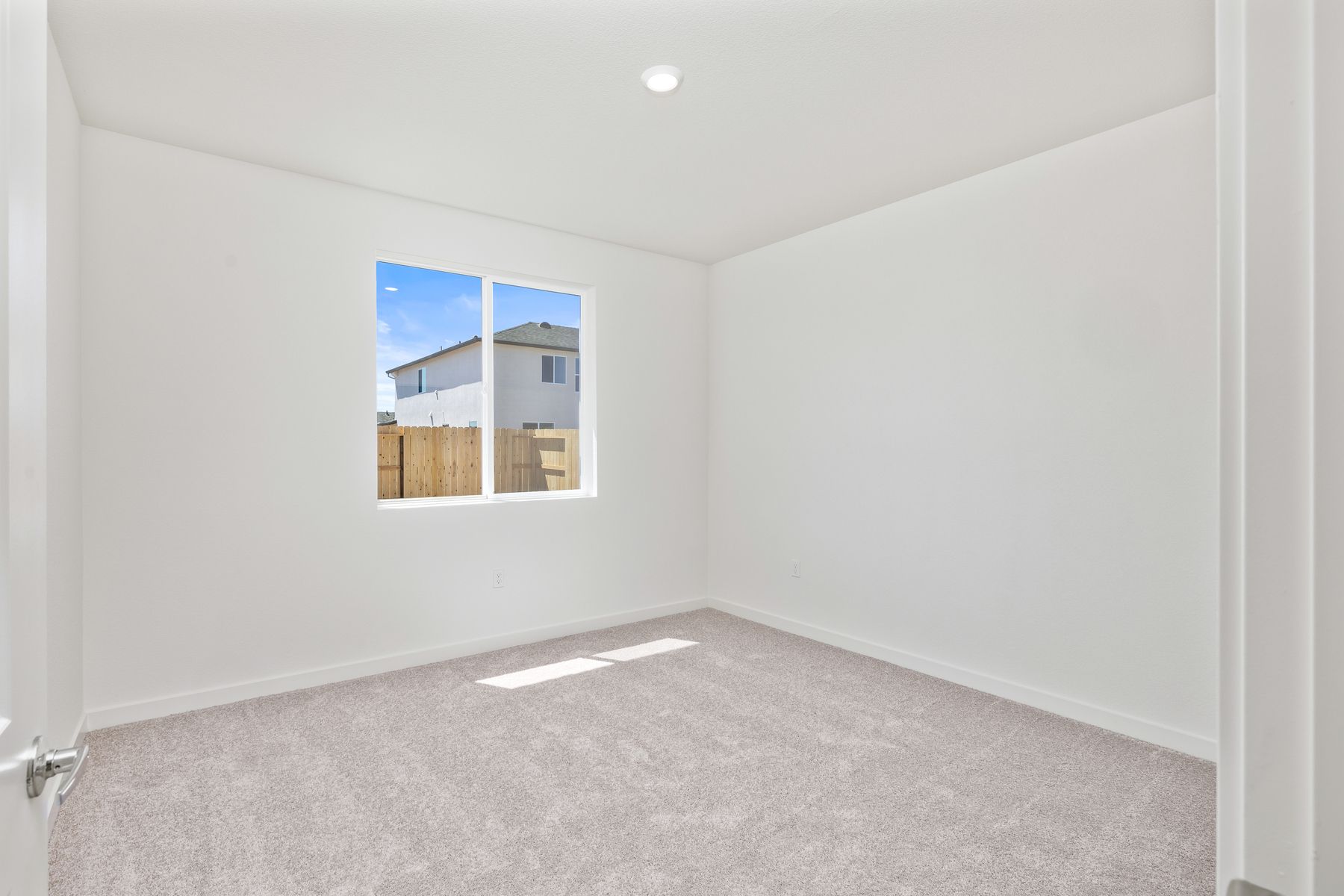 The master bedroom is spacious and has carpet.