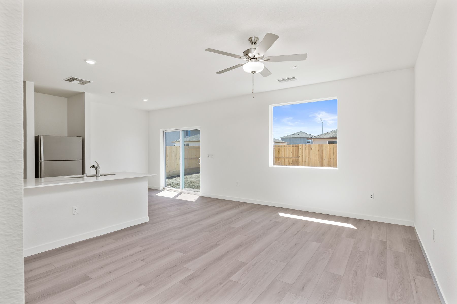 The family room is spacious with a ceiling fan.