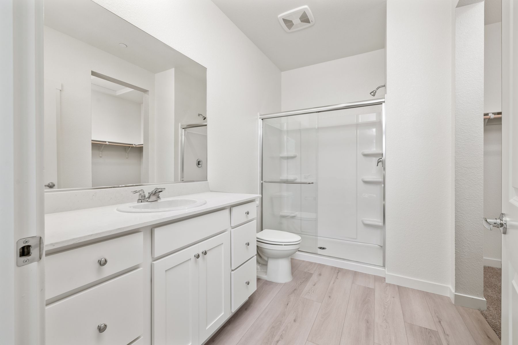 The master bathroom has a dual sink vanity.