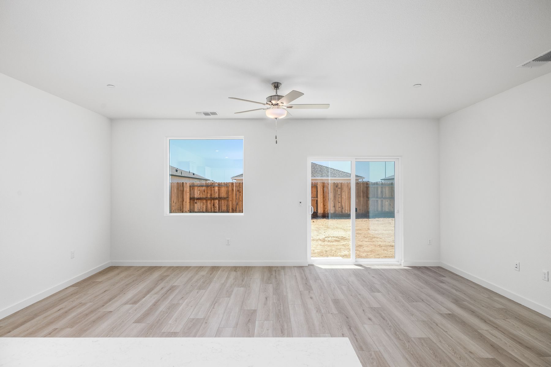 The family room is spacious with a ceiling fan.