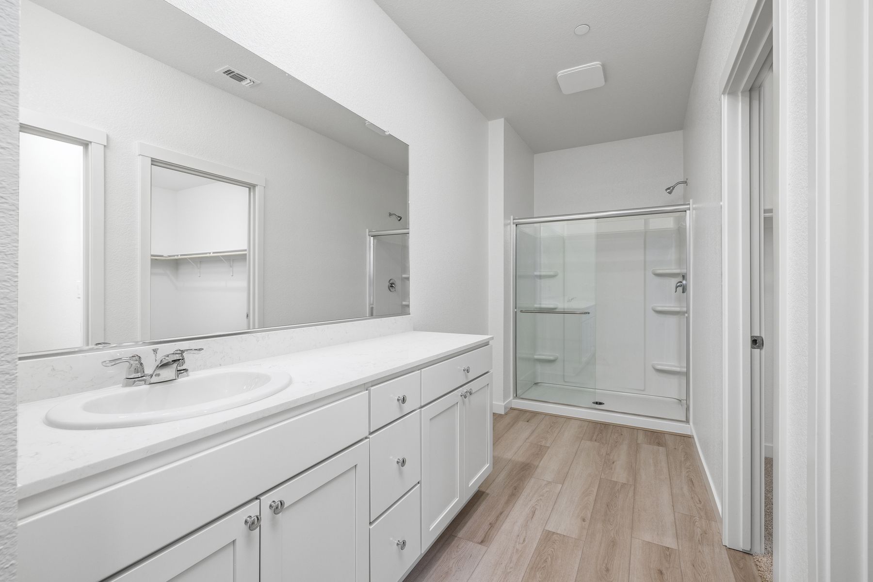 The master bathroom has a large vanity.