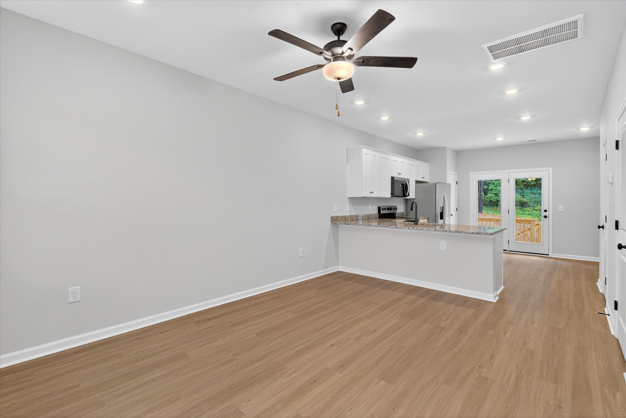Vinyl plank flooring throughout. 