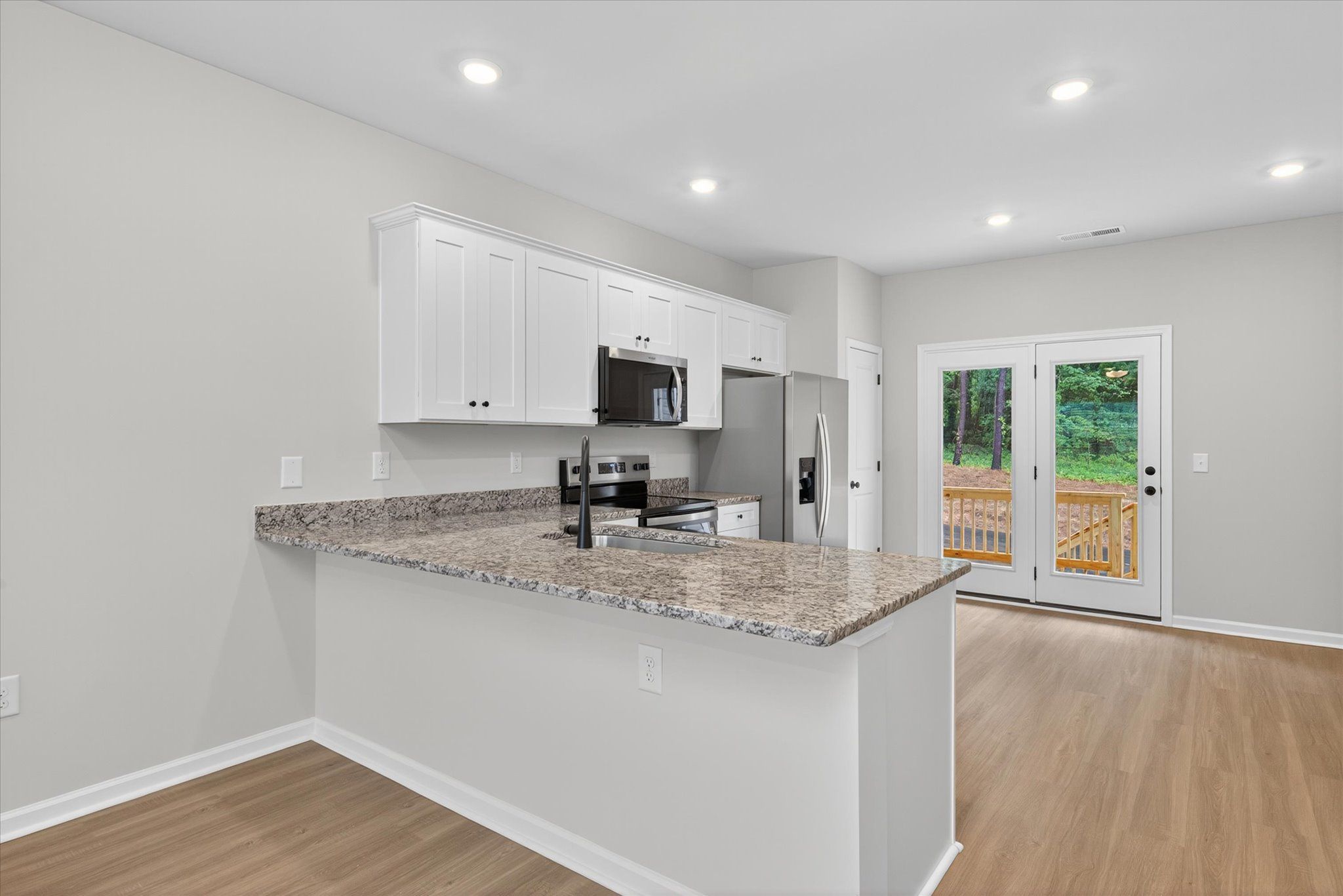 The kitchen comes with stainless-steel appliances. 