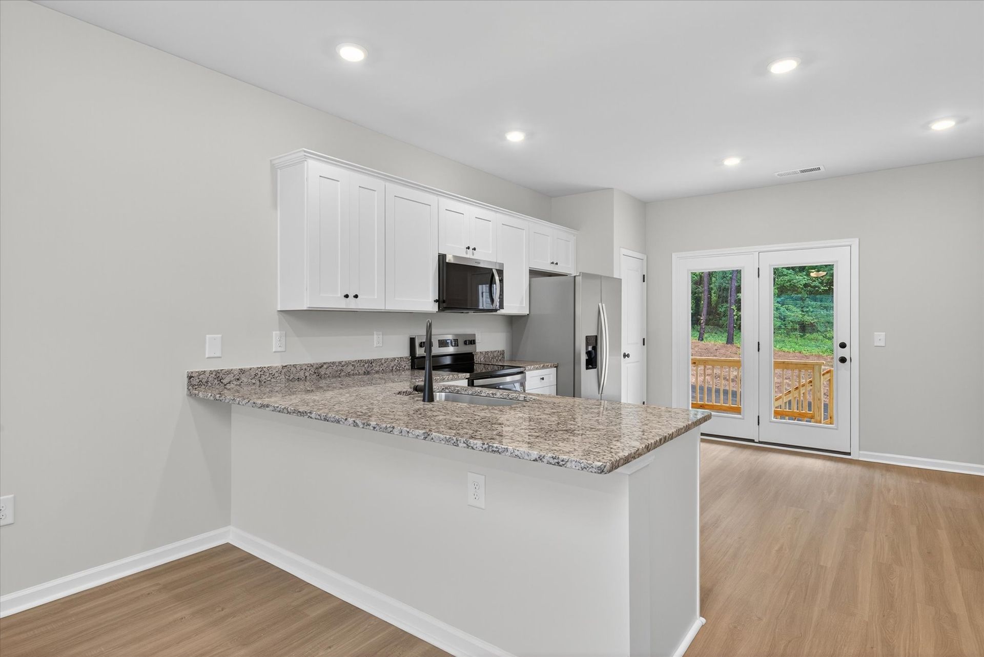 The kitchen comes with stainless-steel appliances. 