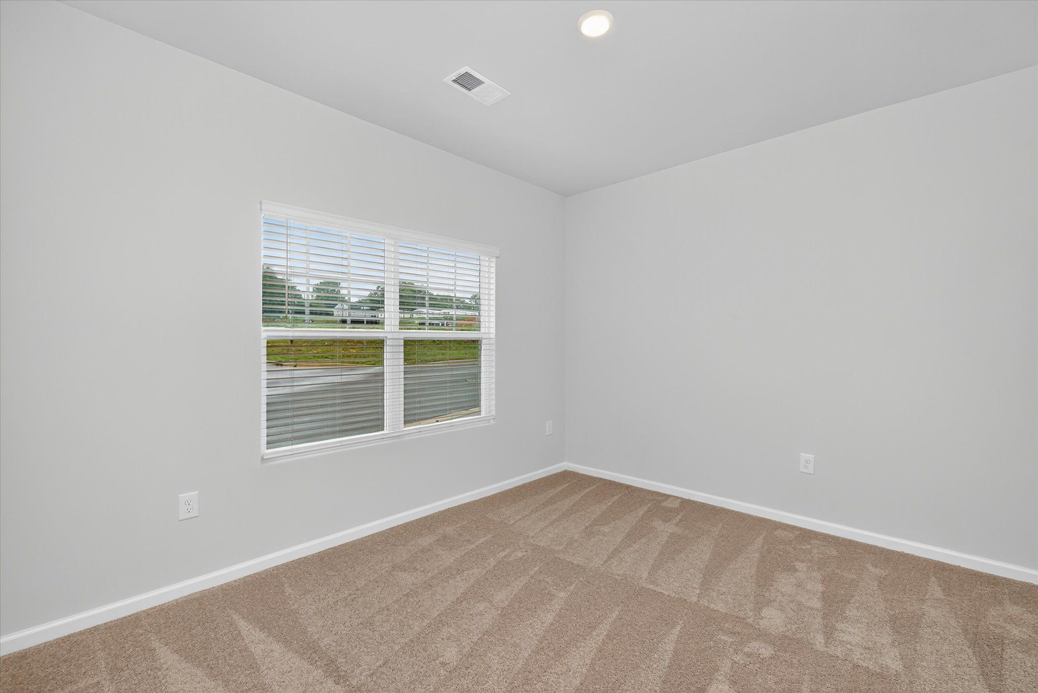 Windows let in lots of light to the master bedroom