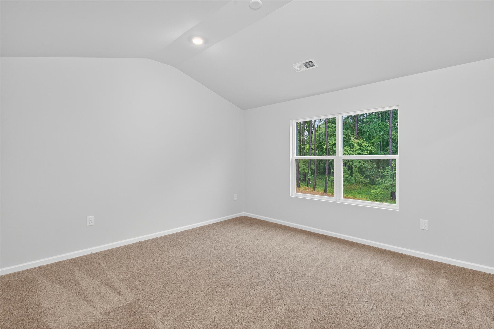 Windows let in lots of light to the master bedroom