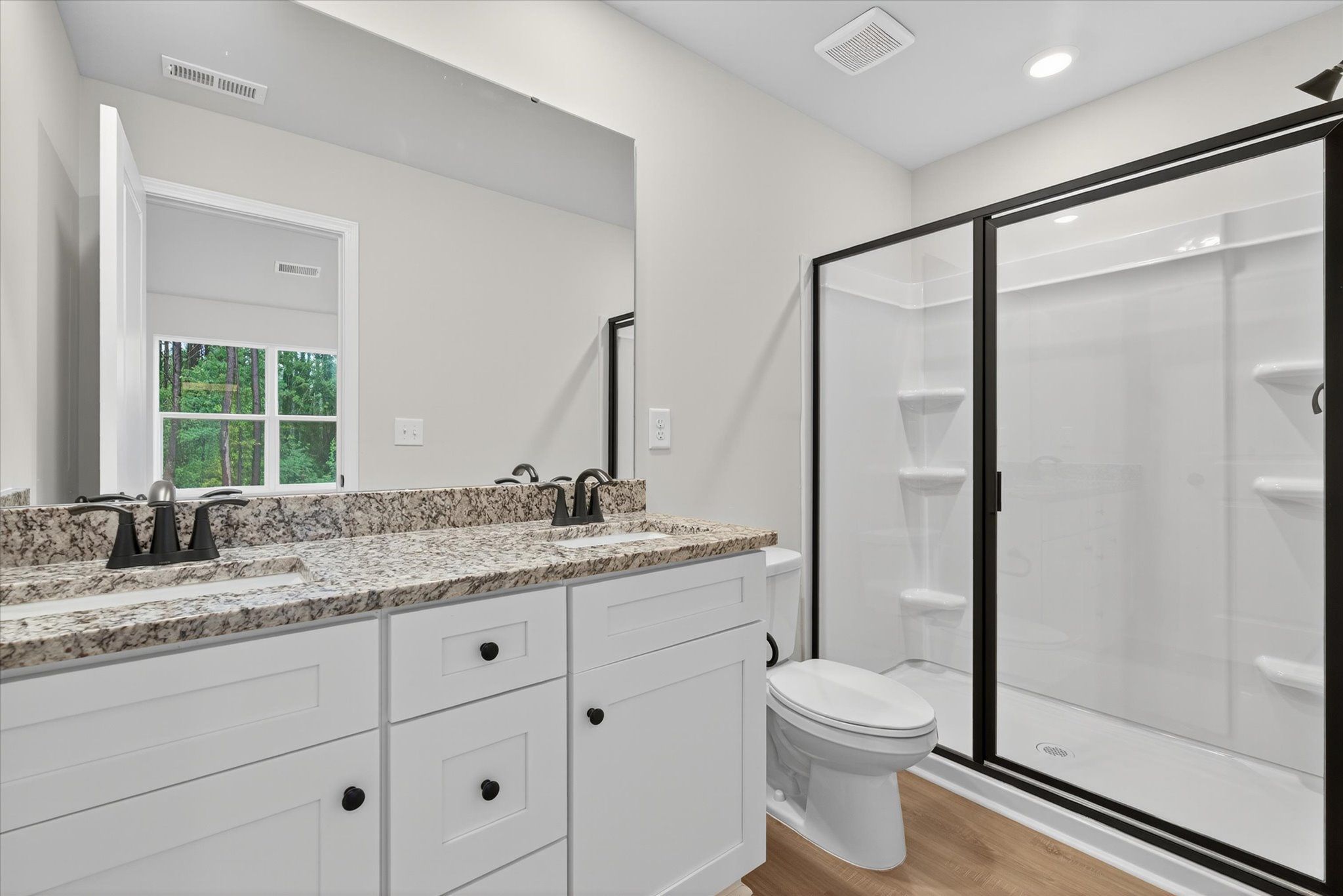 The master bathroom has a glass-enclosed shower