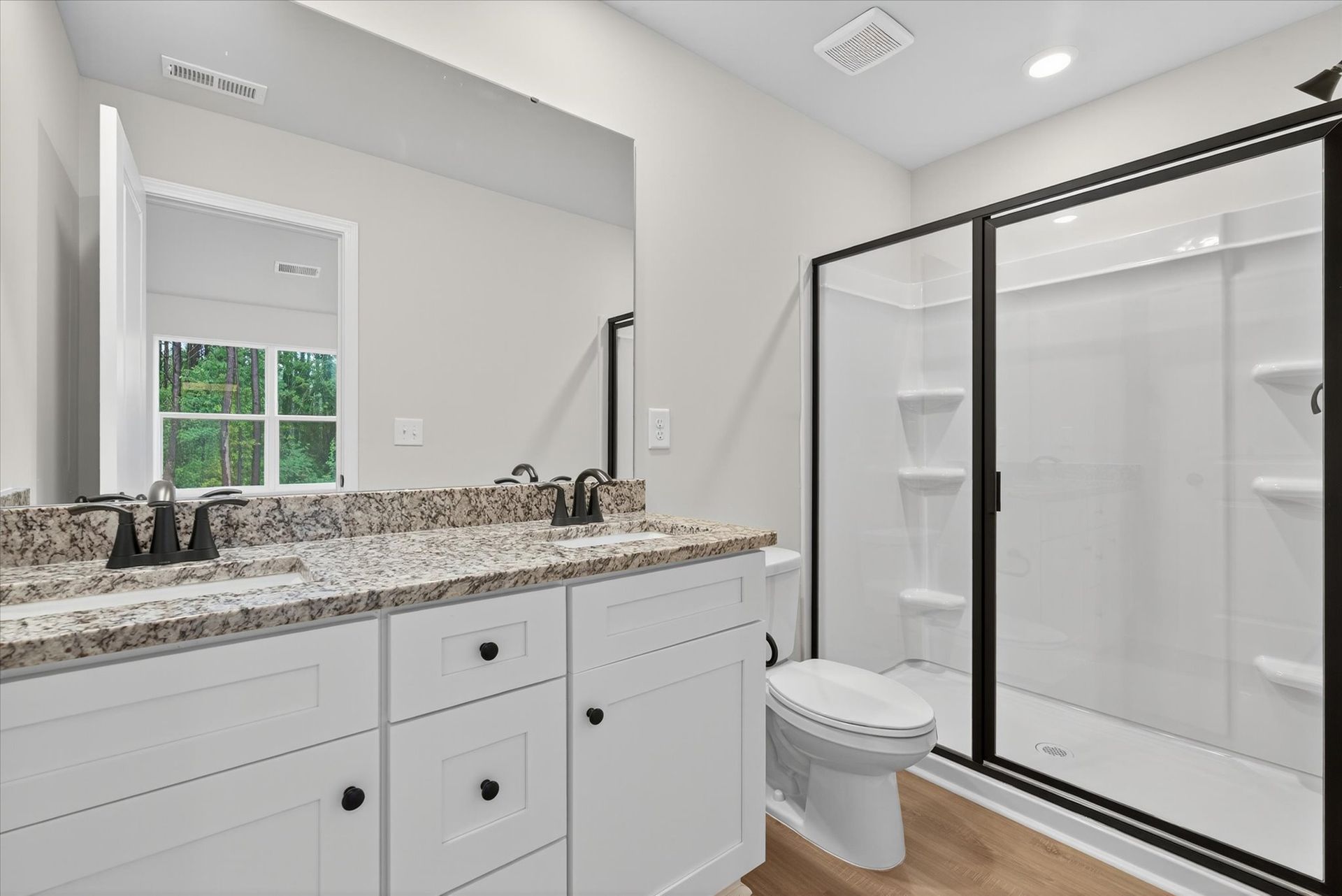 The master bathroom has a glass-enclosed shower