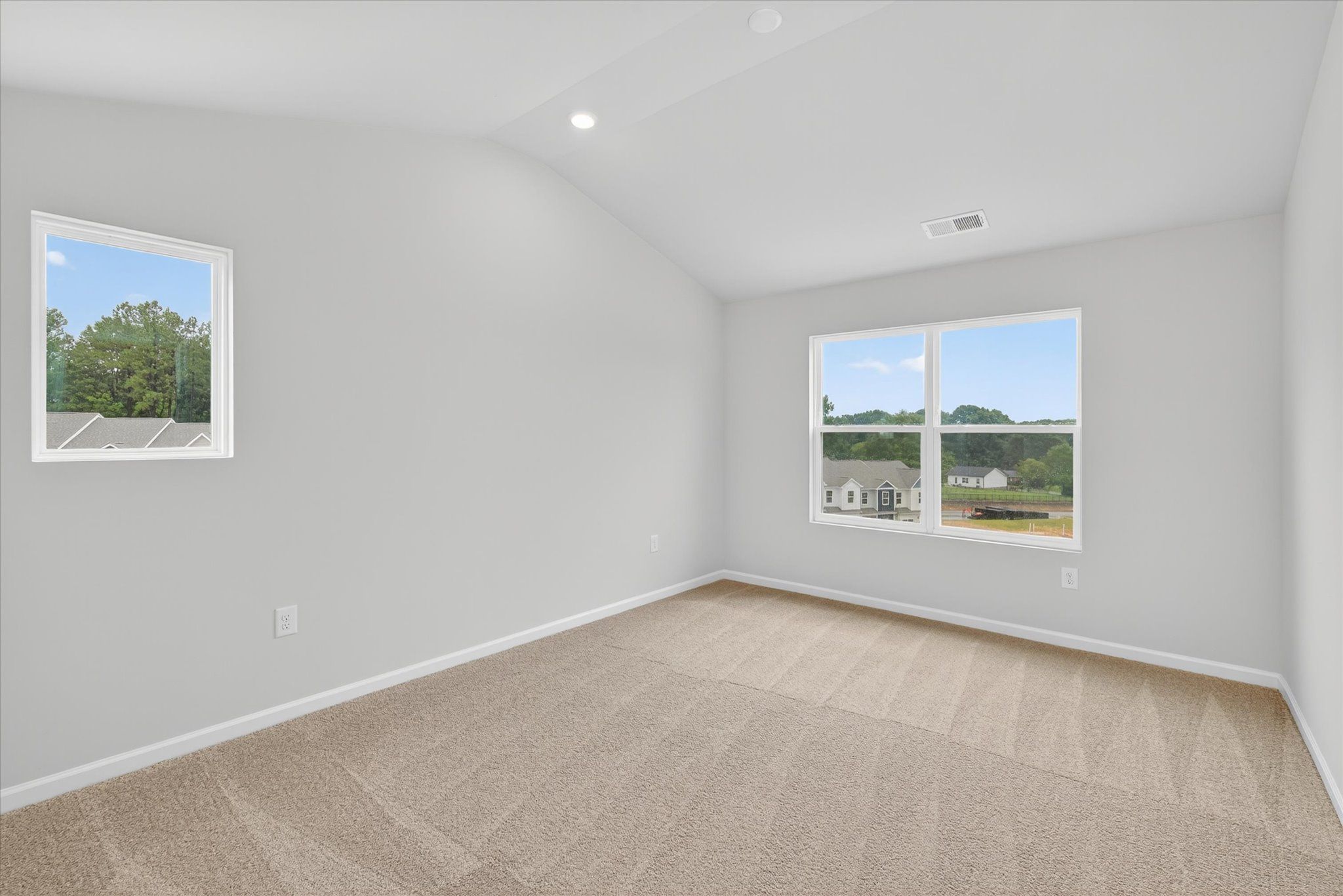 Windows let in lots of light to the master bedroom