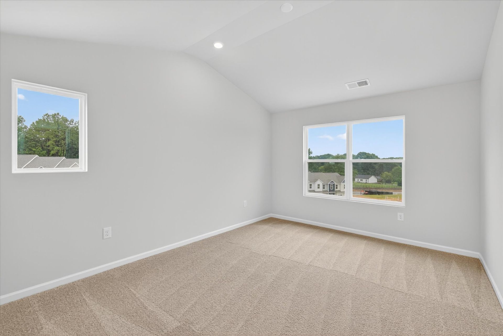 Windows let in lots of light to the master bedroom