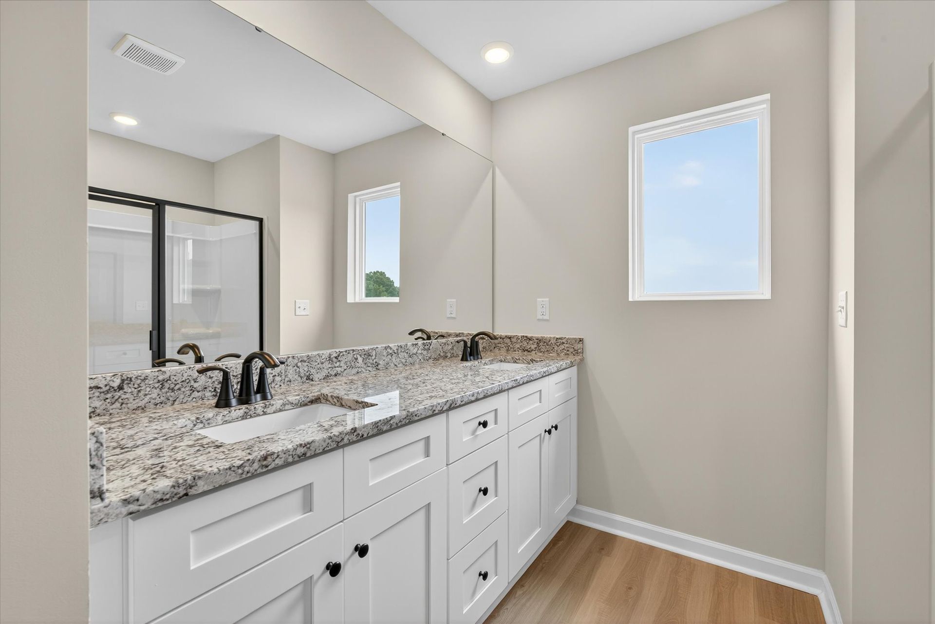 The master bathroom has a glass-enclosed shower