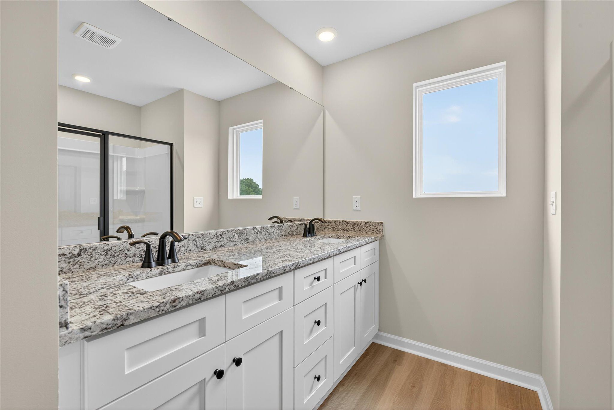 The master bathroom has a glass-enclosed shower