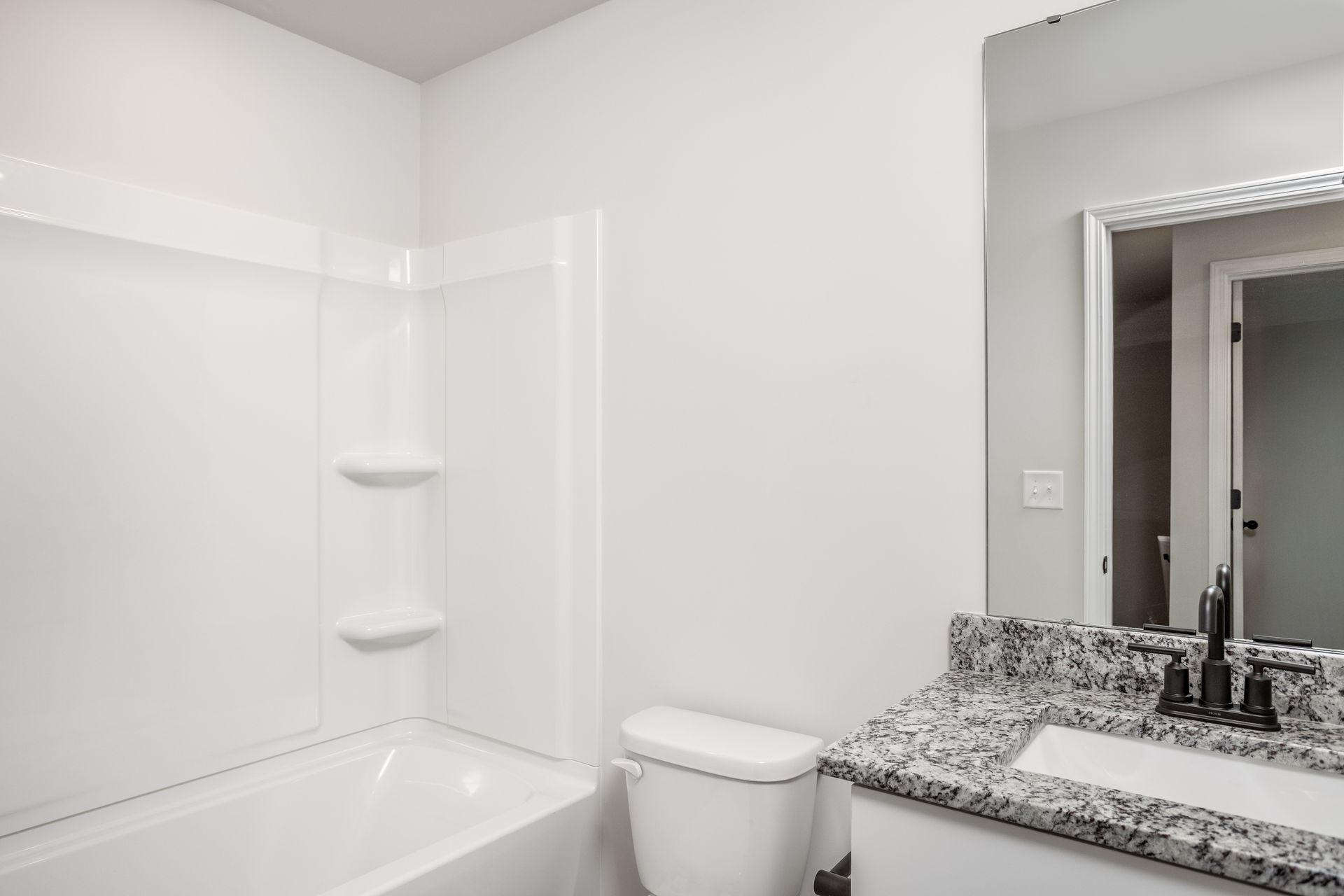 The secondary bathroom has a large soaking tub.