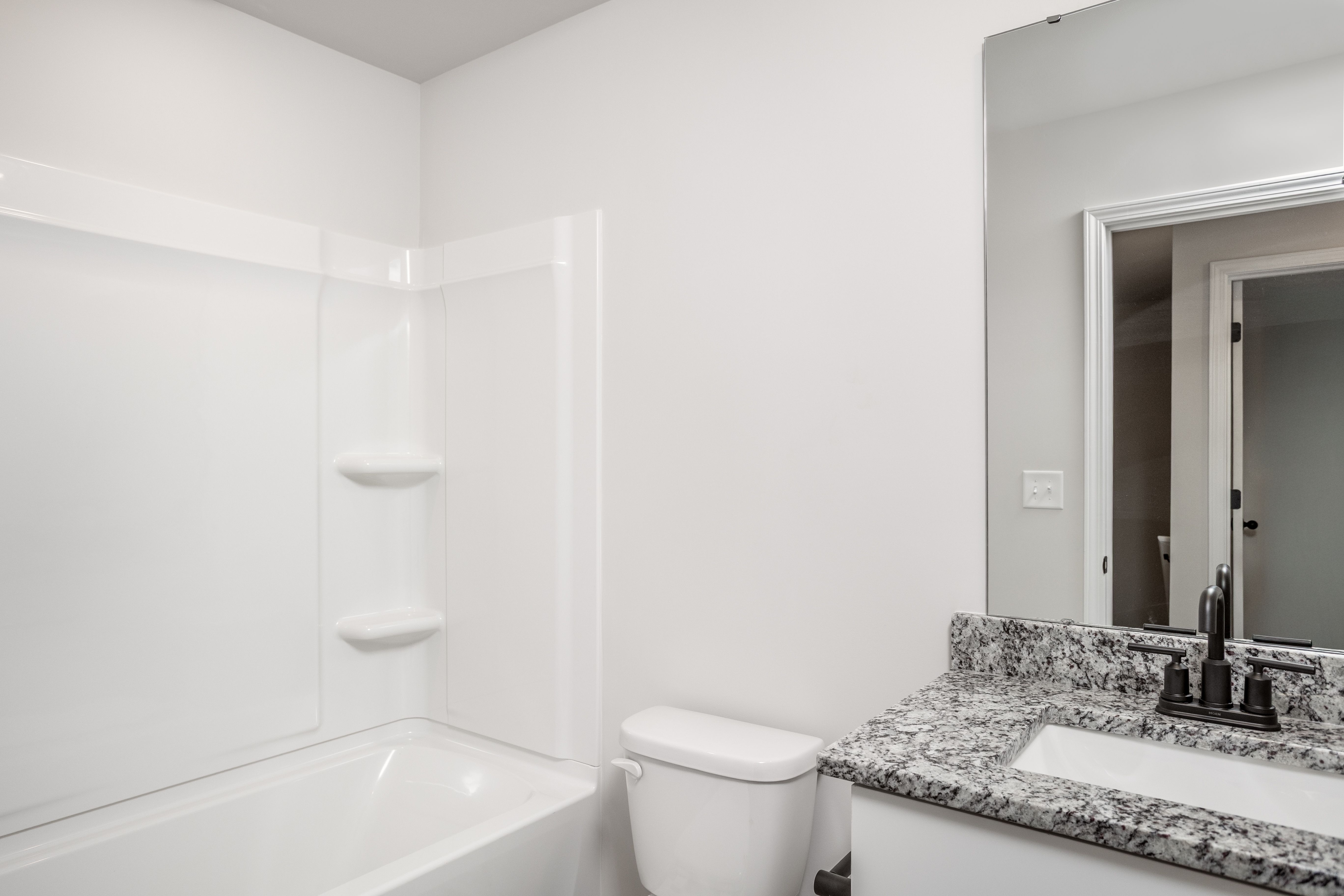 The secondary bathroom has a large soaking tub.