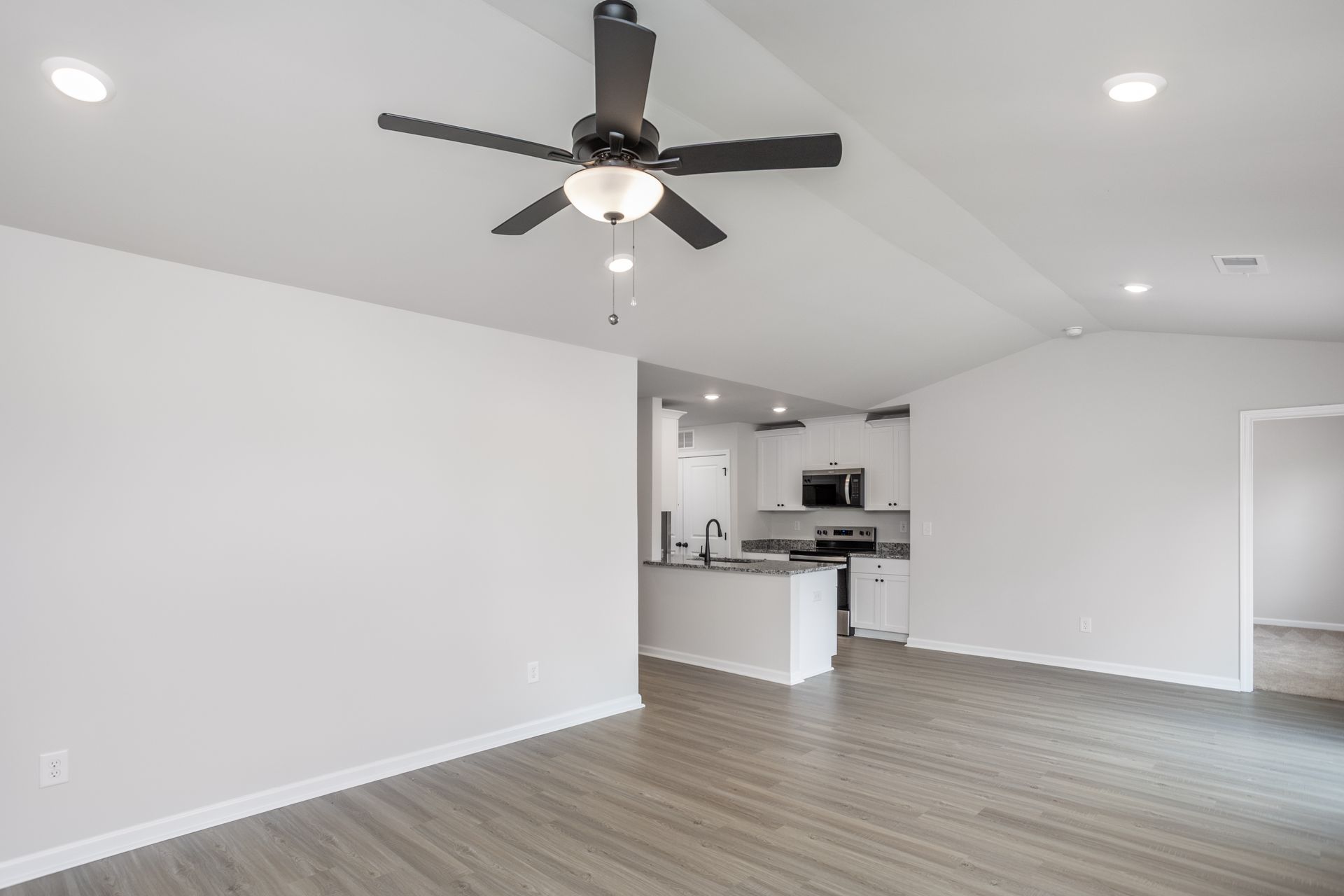 Living room has vinyl plank flooring