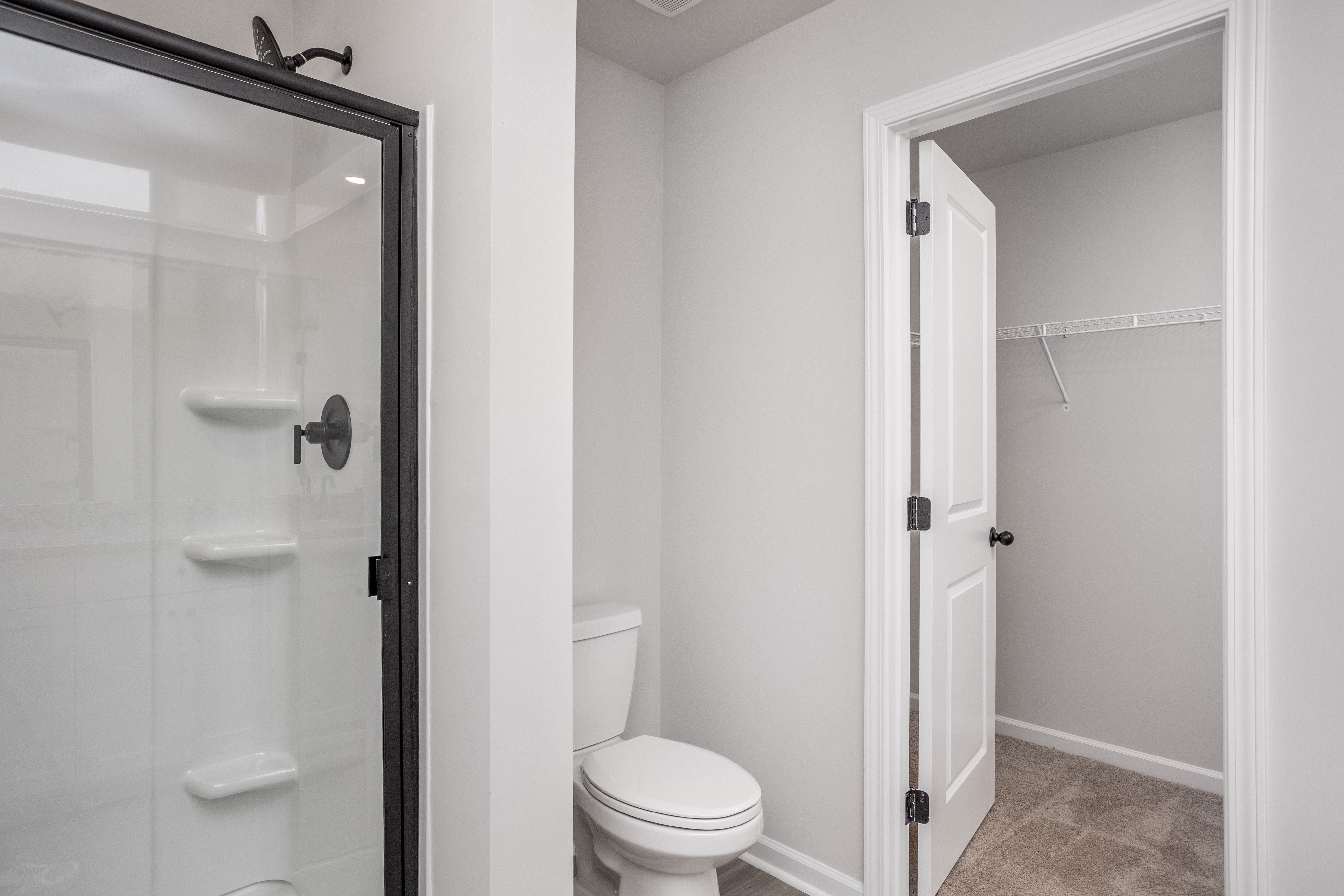 This bathroom has a glass-enclosed shower