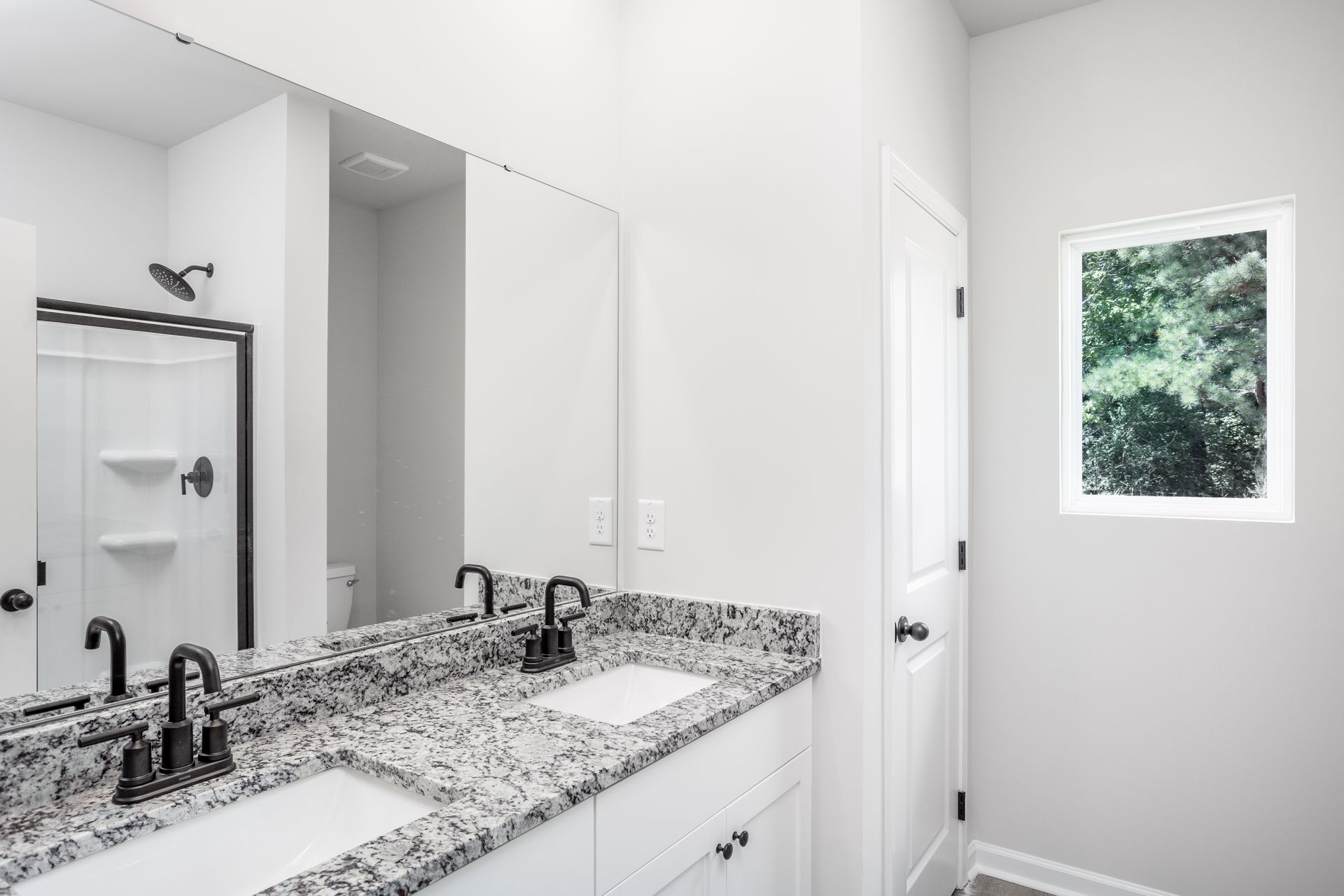 This bathroom has granite countertops