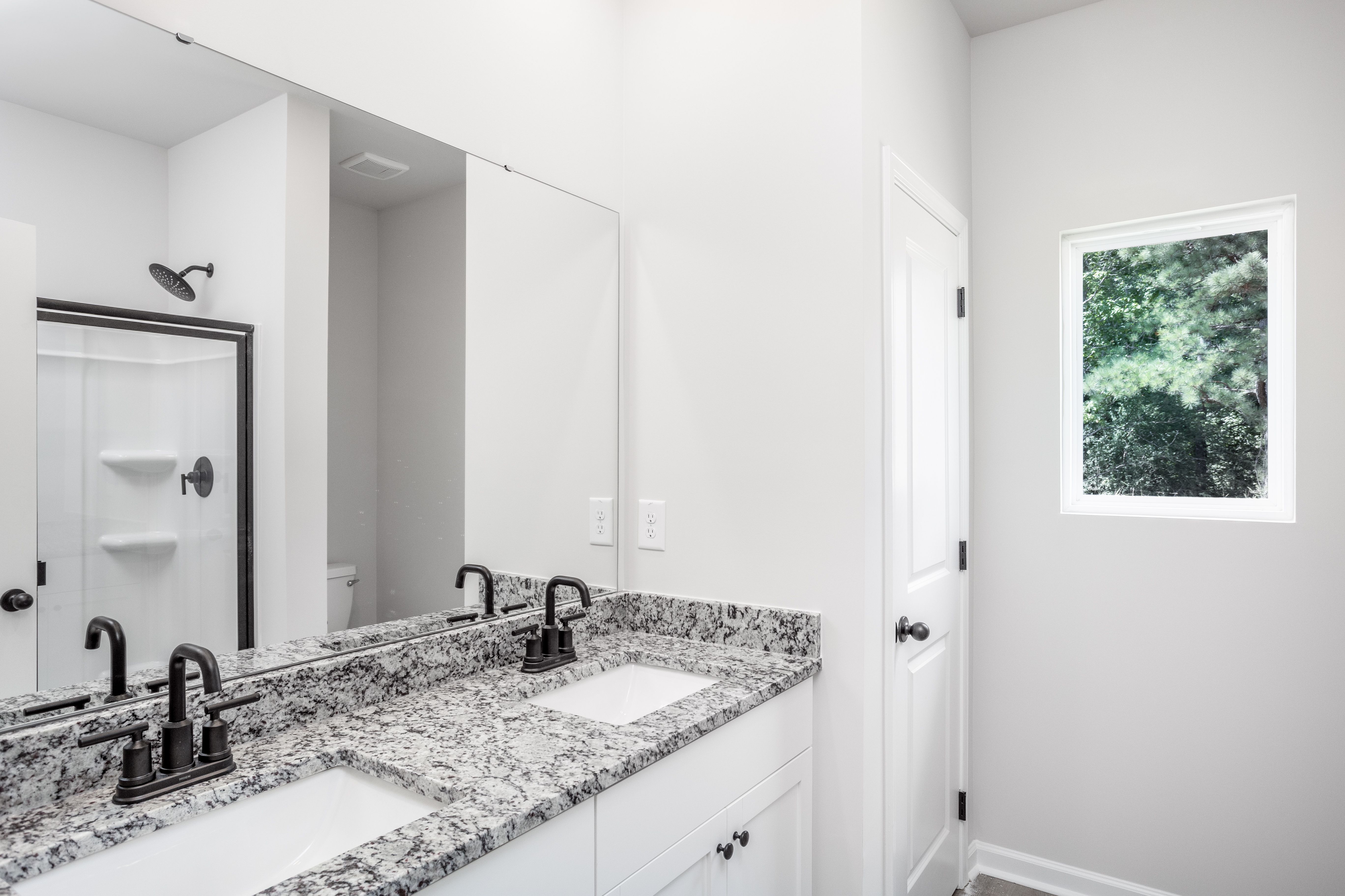 This bathroom has granite countertops