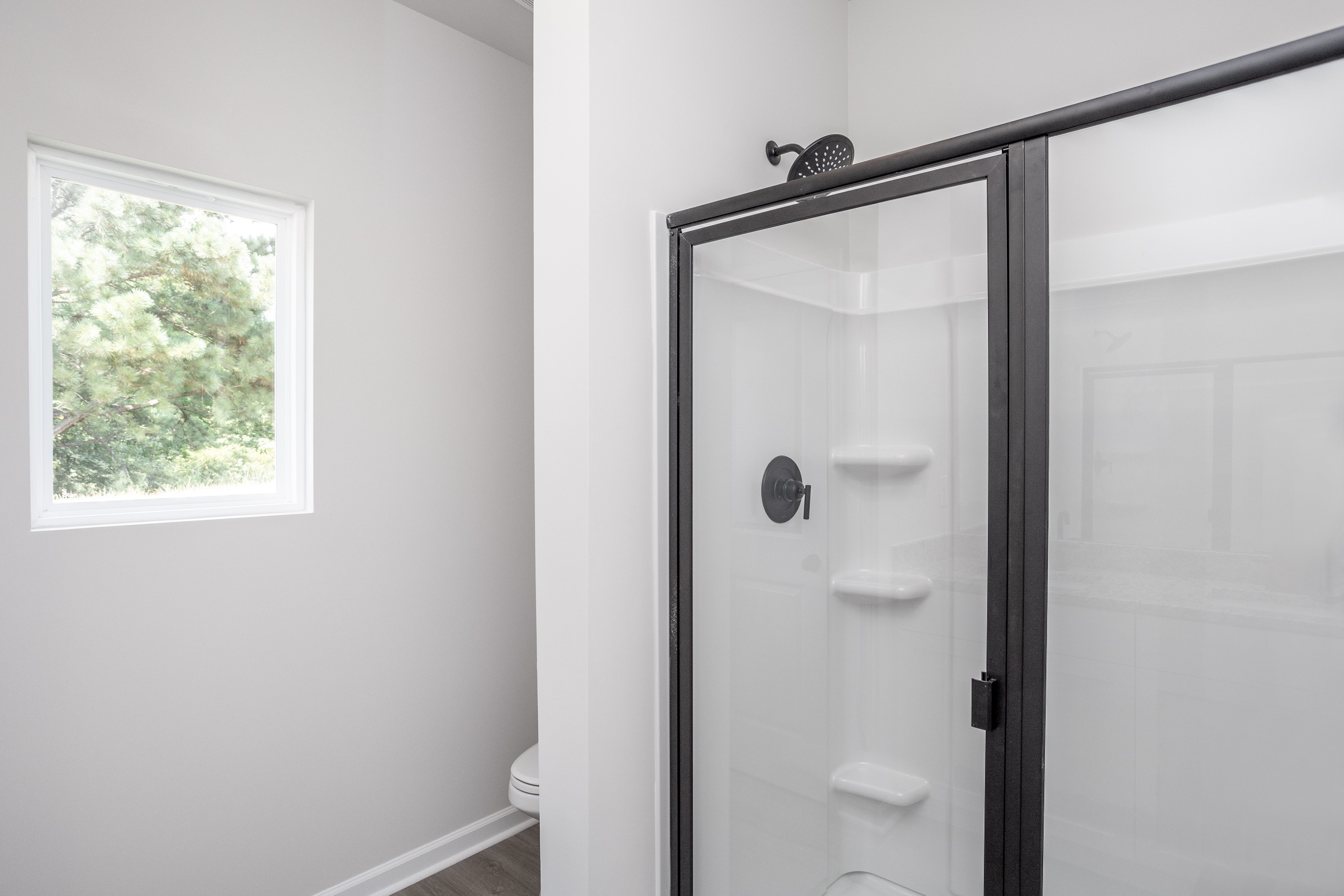 This bathroom has a glass-enclosed shower