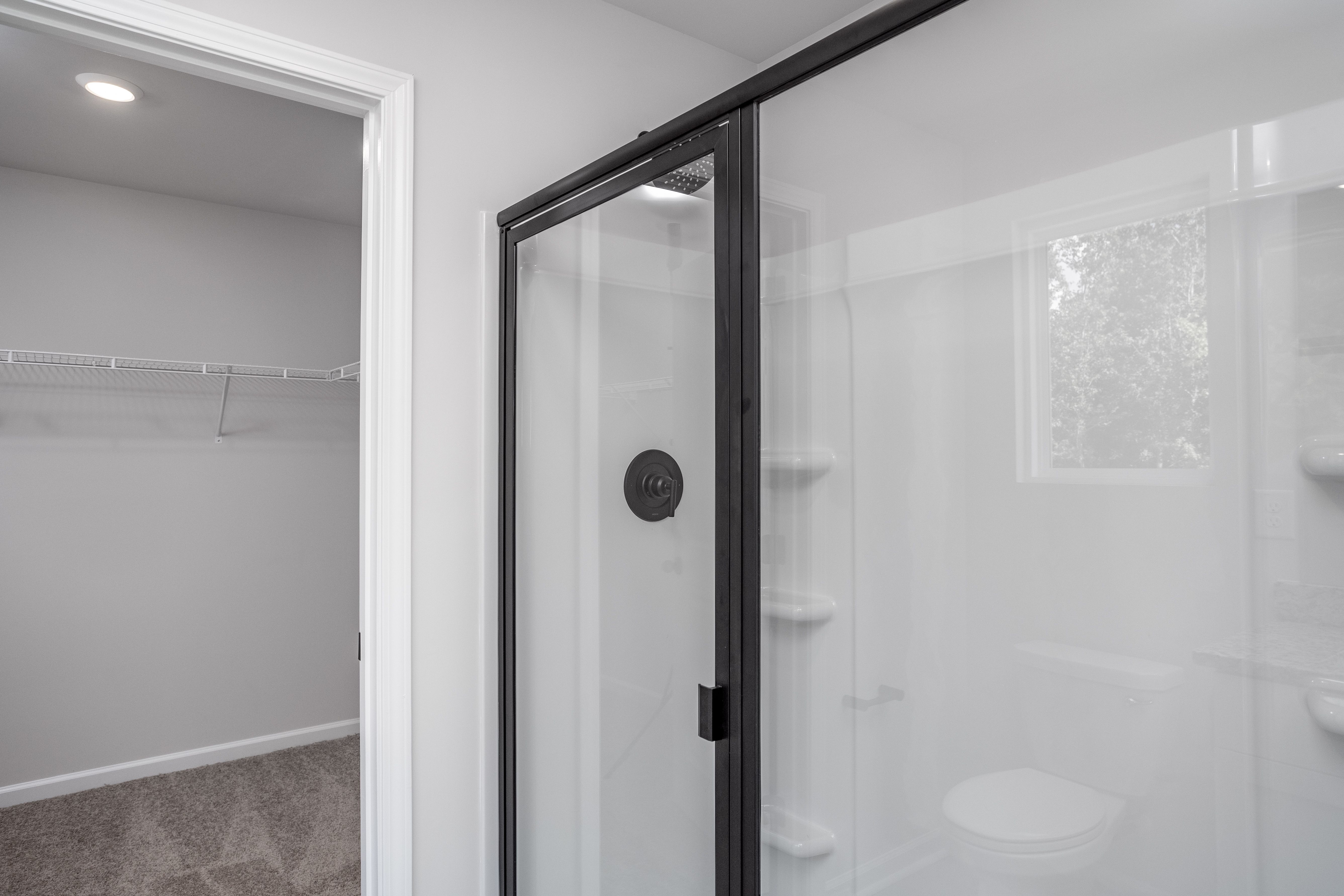 This bathroom has a glass-enclosed shower